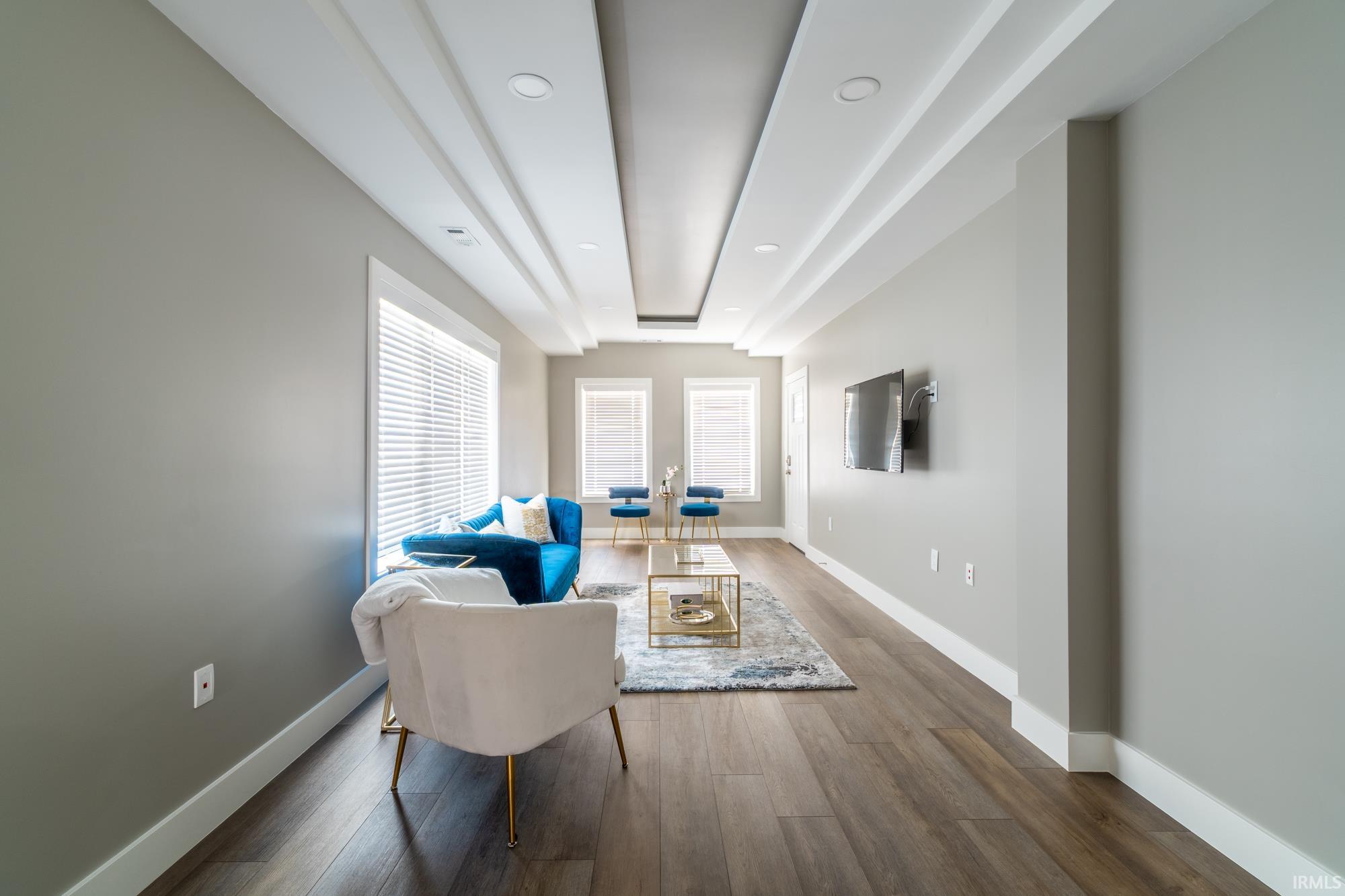 Sitting room featuring dark wood-style floors and recessed lighting