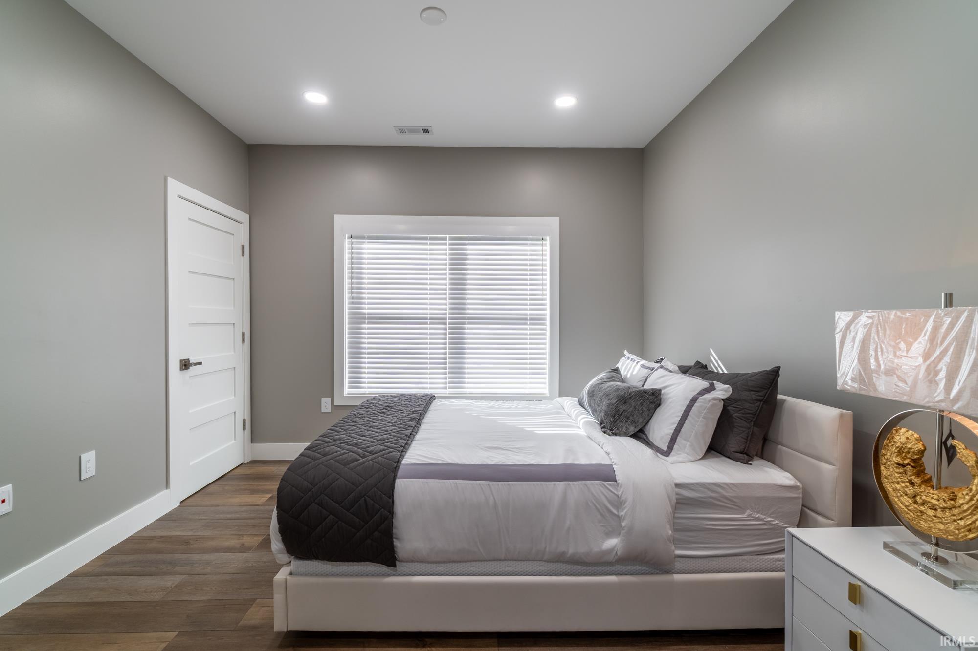 Bedroom featuring dark wood-style flooring and recessed lighting