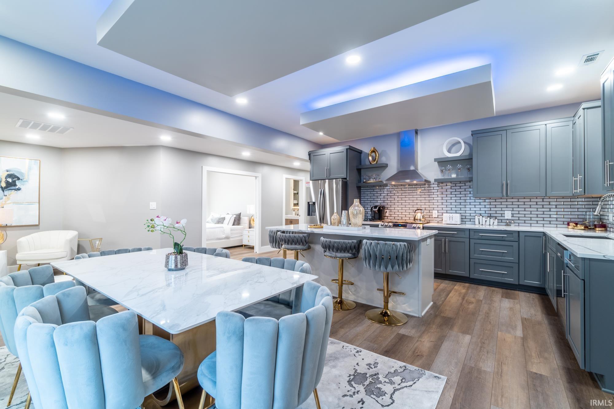 Dining room with dark wood finished floors and recessed lighting