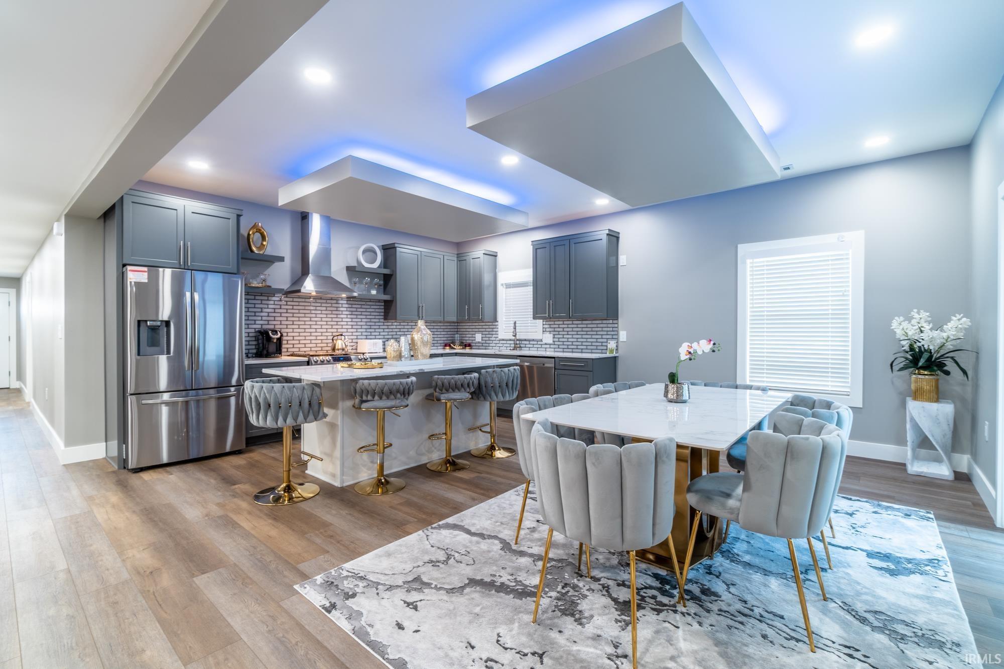 Dining space with light wood-style flooring and recessed lighting
