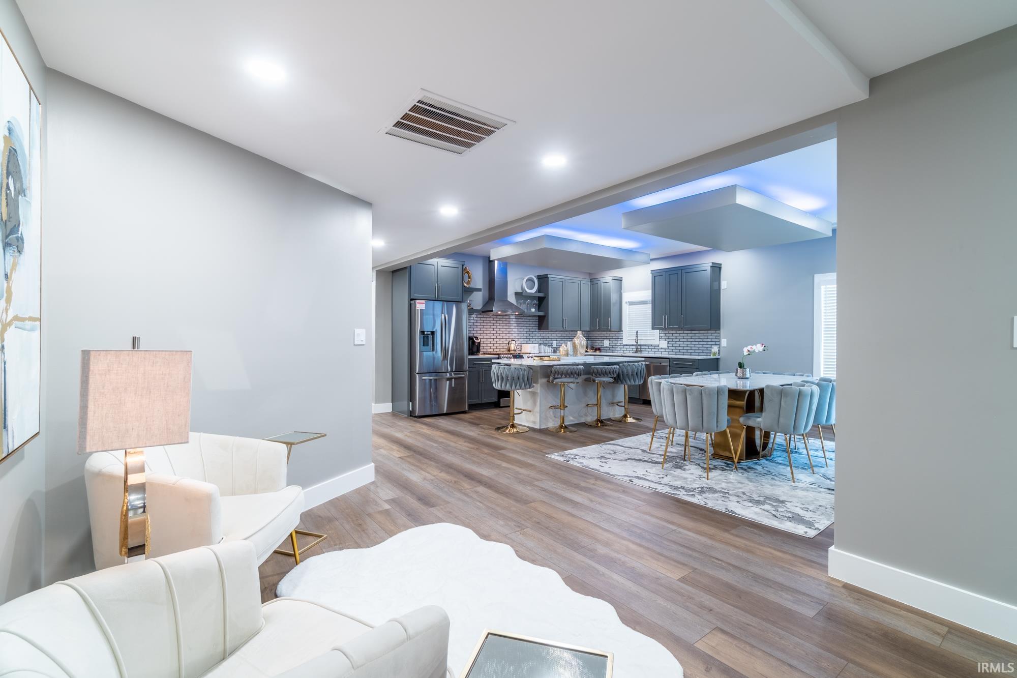 Living area featuring light wood-style floors and baseboards