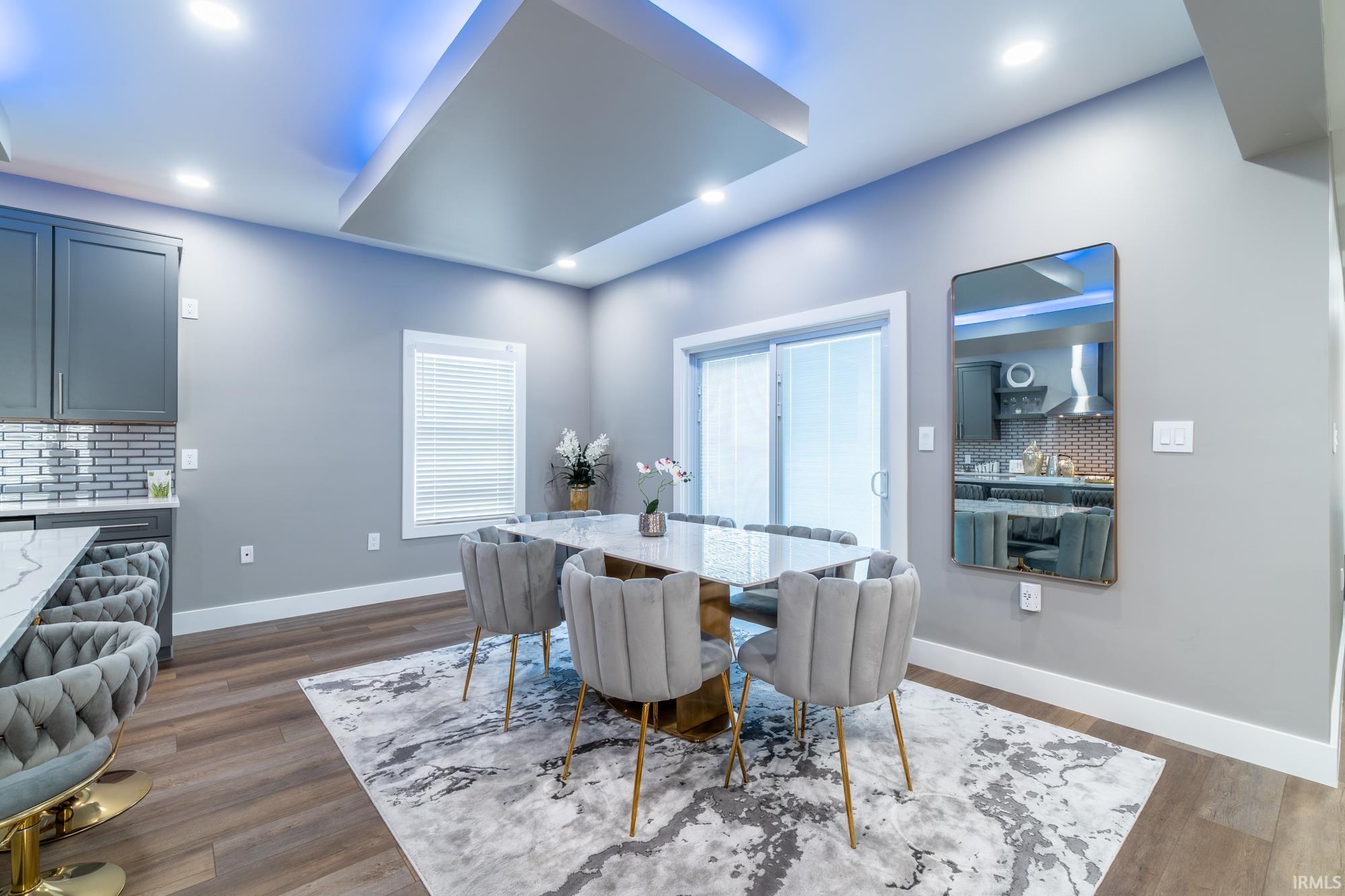Dining area with dark wood-style floors and recessed lighting