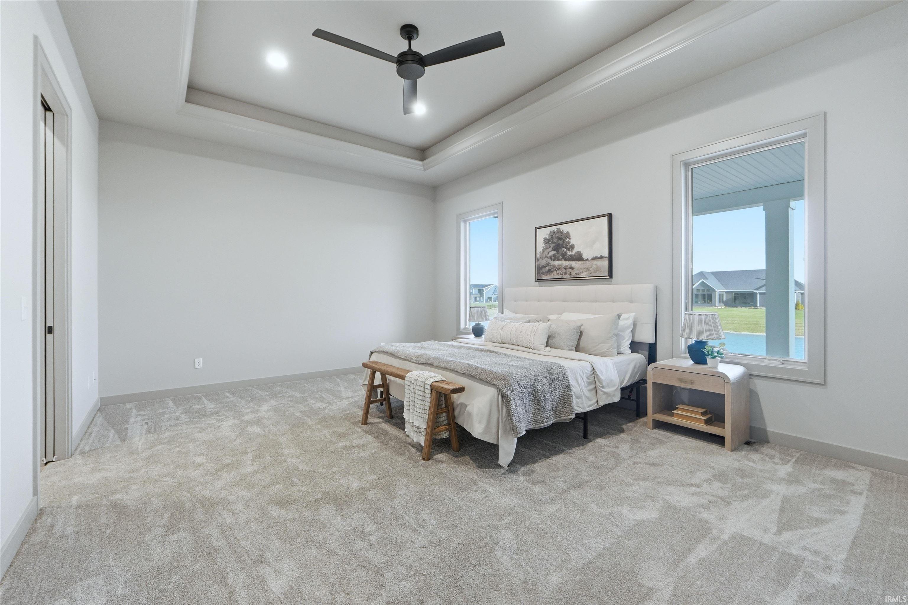 Bedroom with light carpet, ceiling fan, and recessed lighting