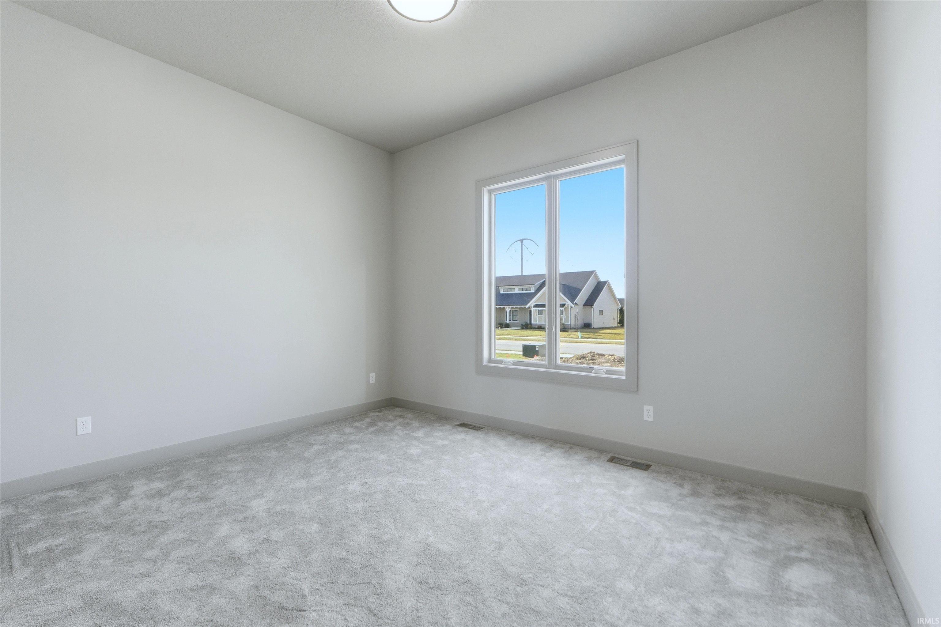 Carpeted empty room with baseboards