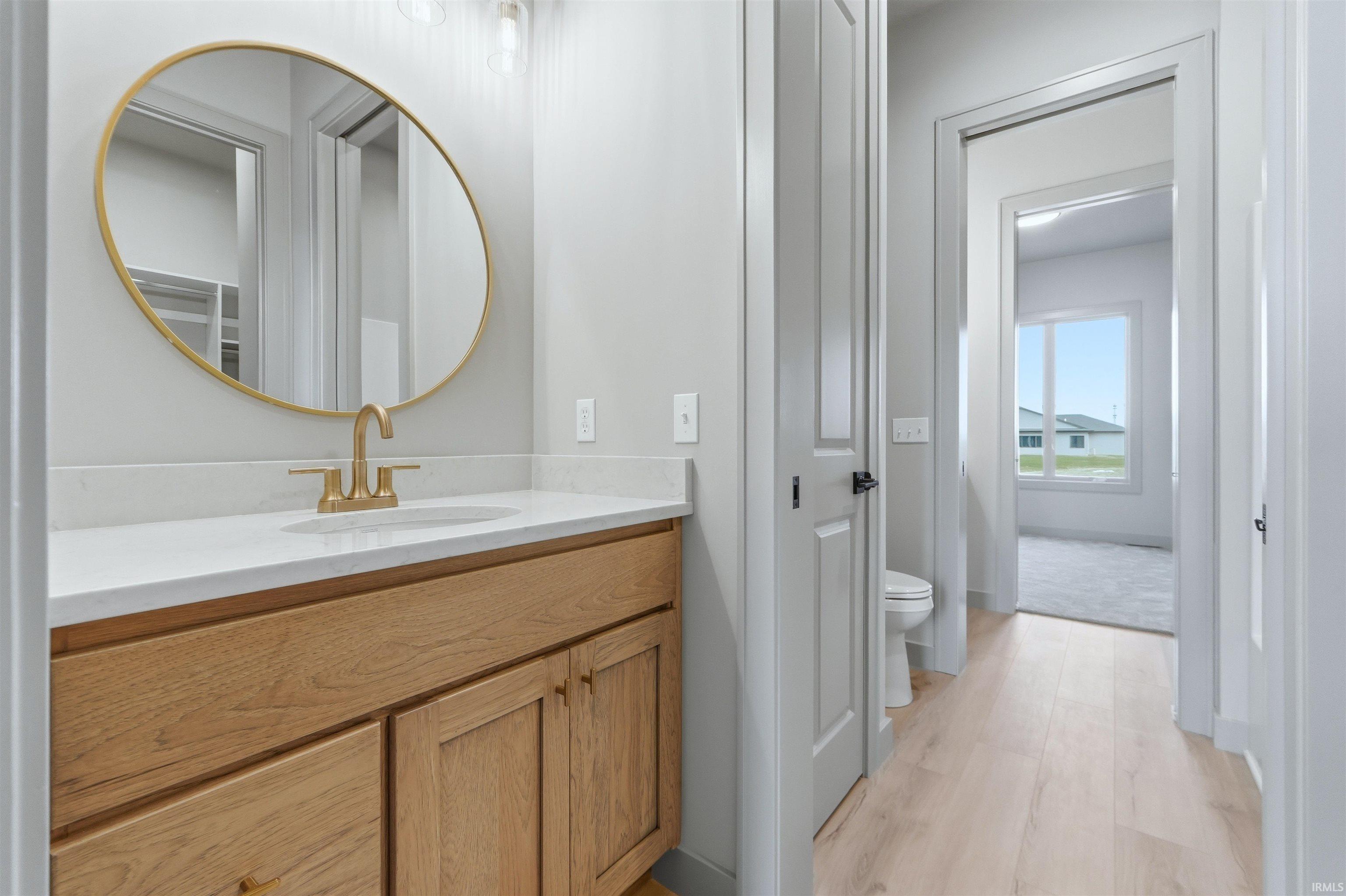 Bathroom with vanity and light wood finished floors