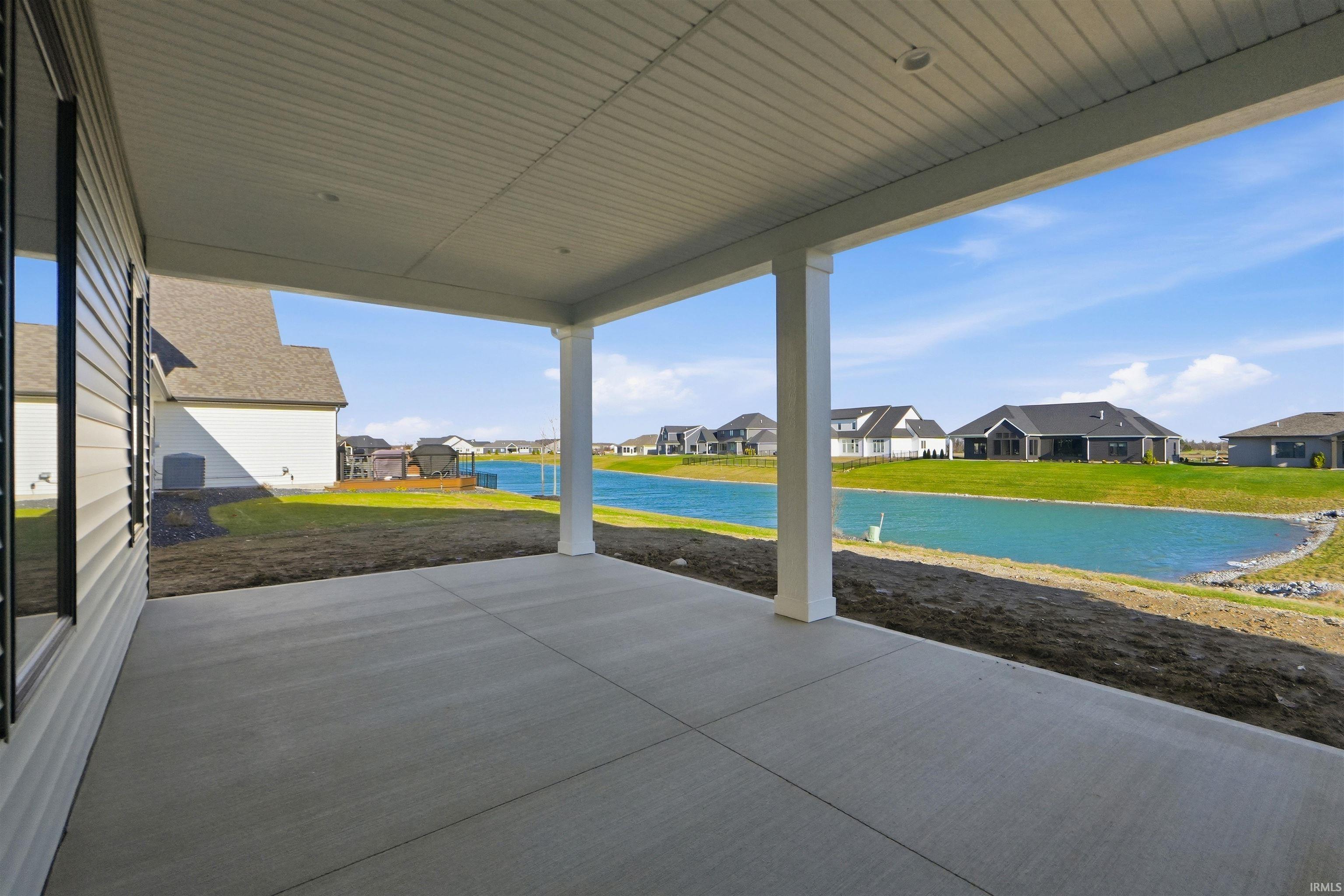 View of patio with a residential view and a water view