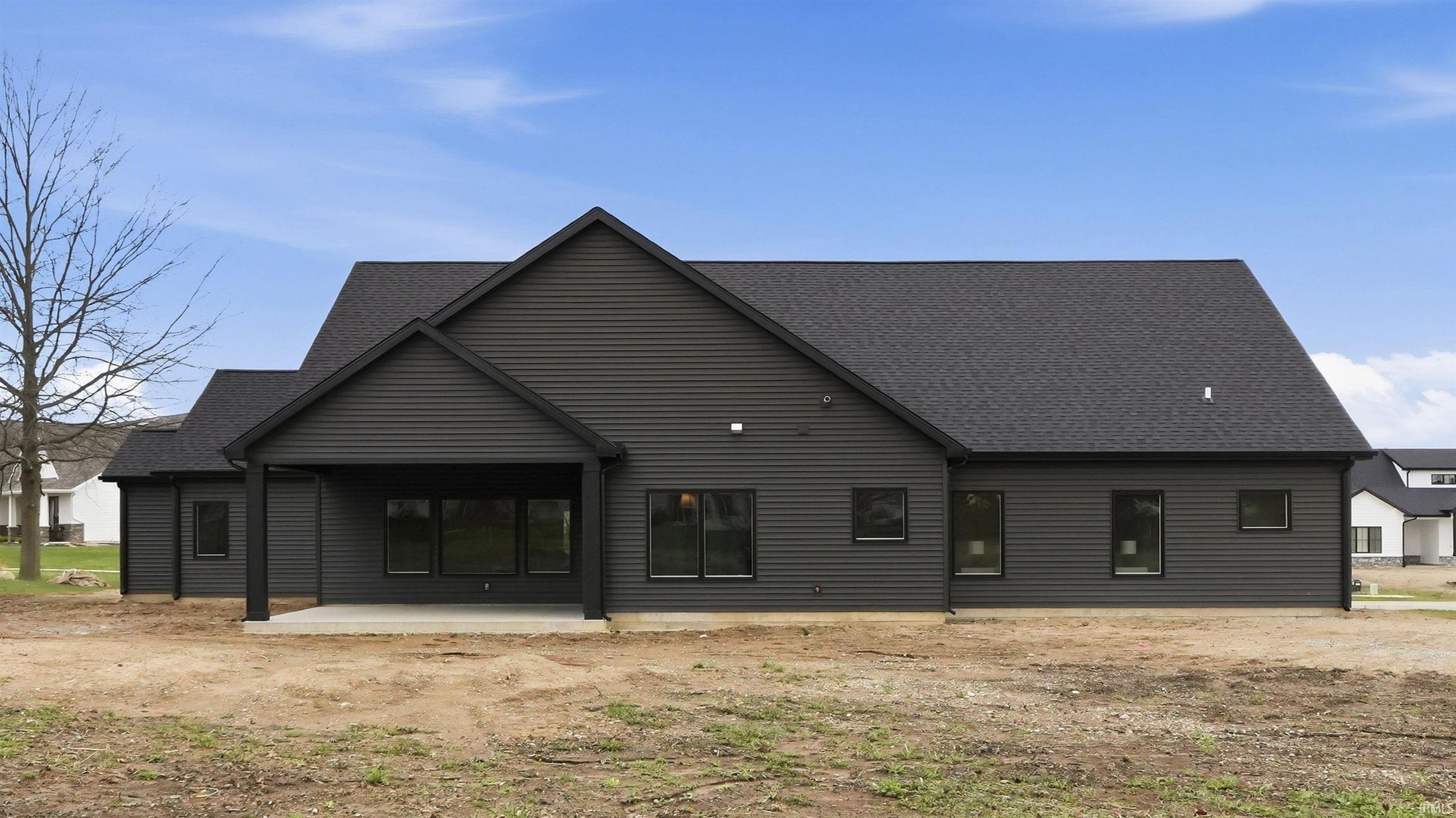 Back of house with a patio and a shingled roof