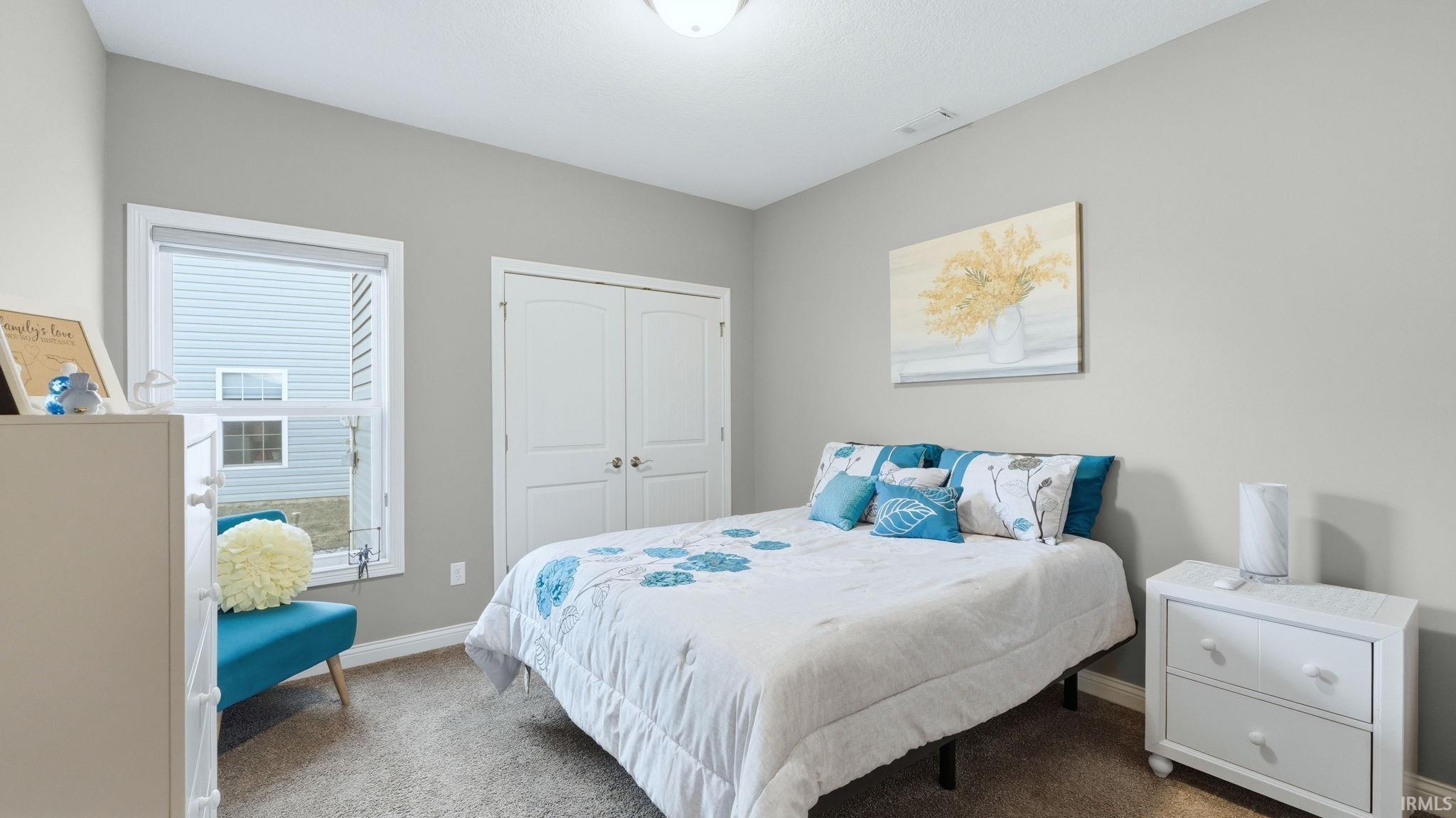 Bedroom featuring carpet floors and a closet