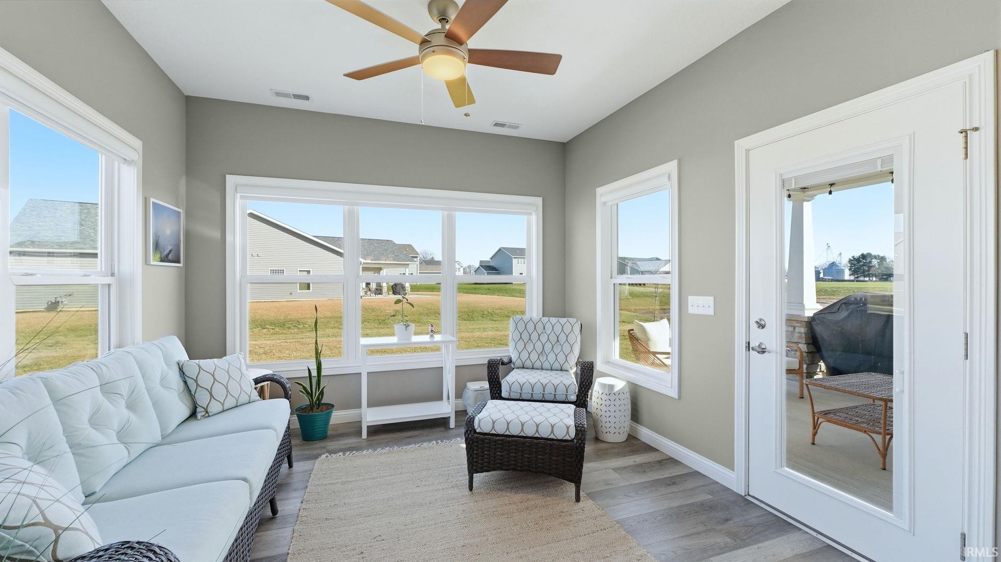 Sunroom / solarium featuring wood finished floors and baseboards