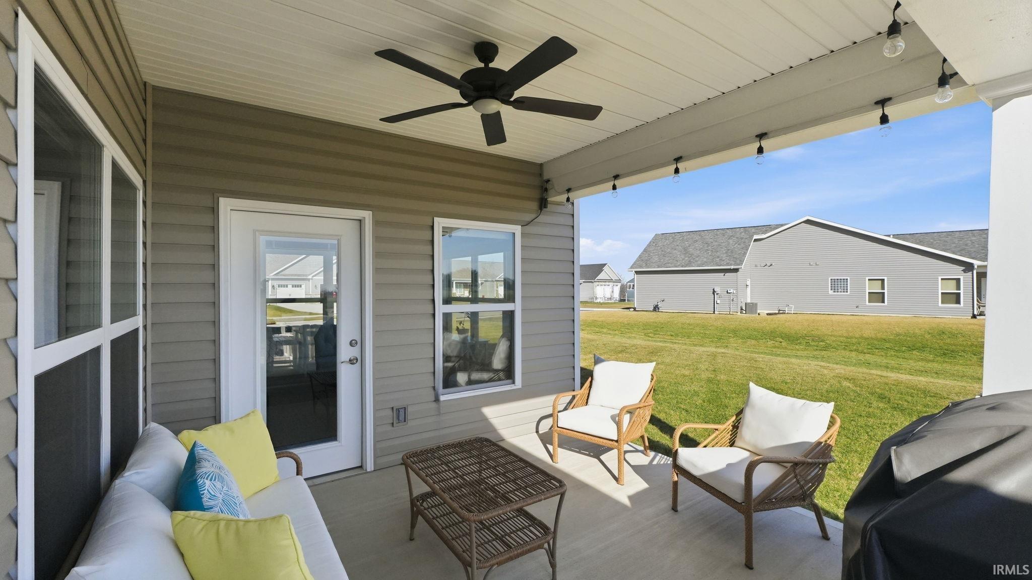 View of patio featuring a ceiling fan, an outdoor living space, and grilling area