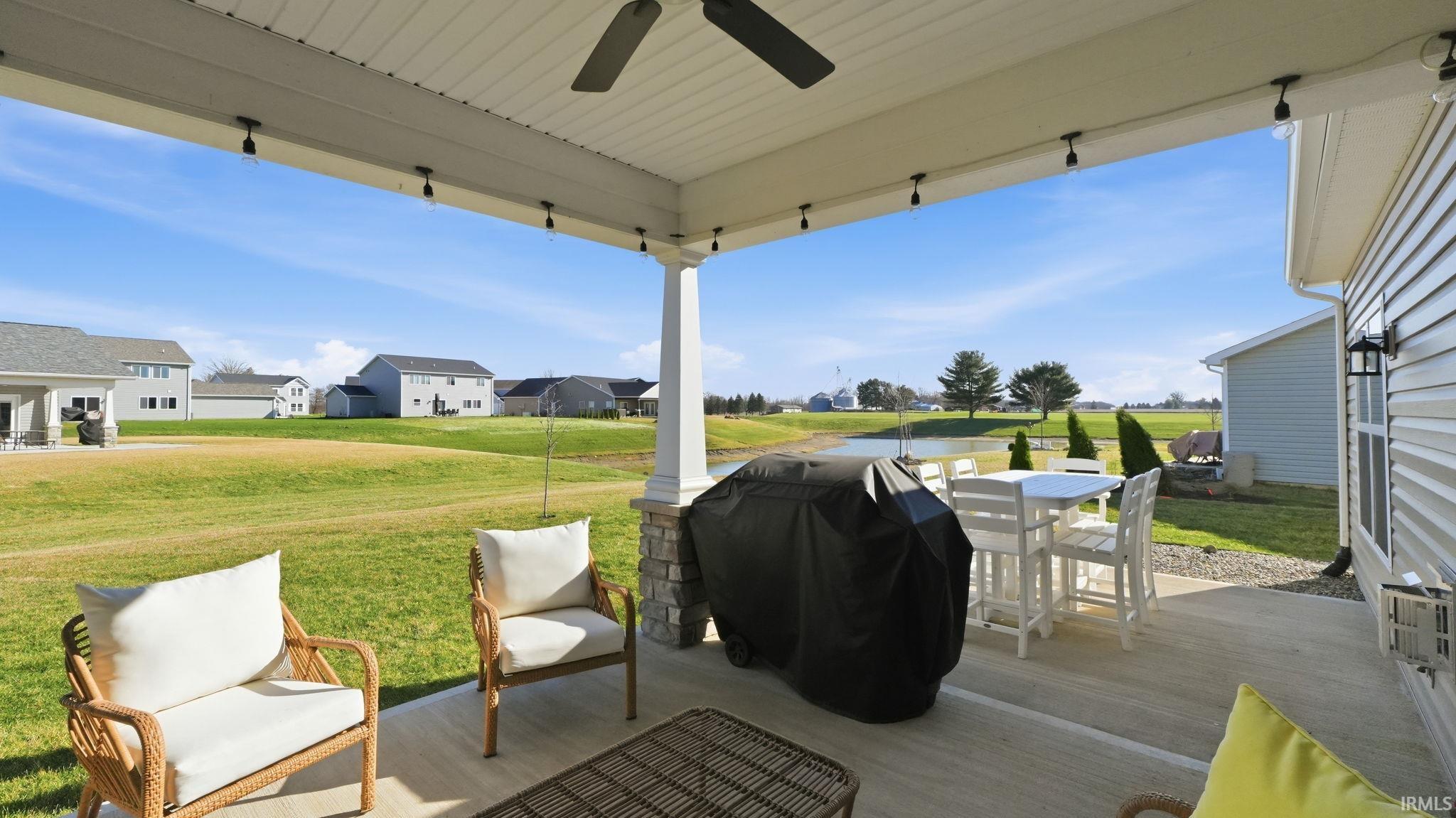 View of patio / terrace with a grill, a ceiling fan, and a residential view