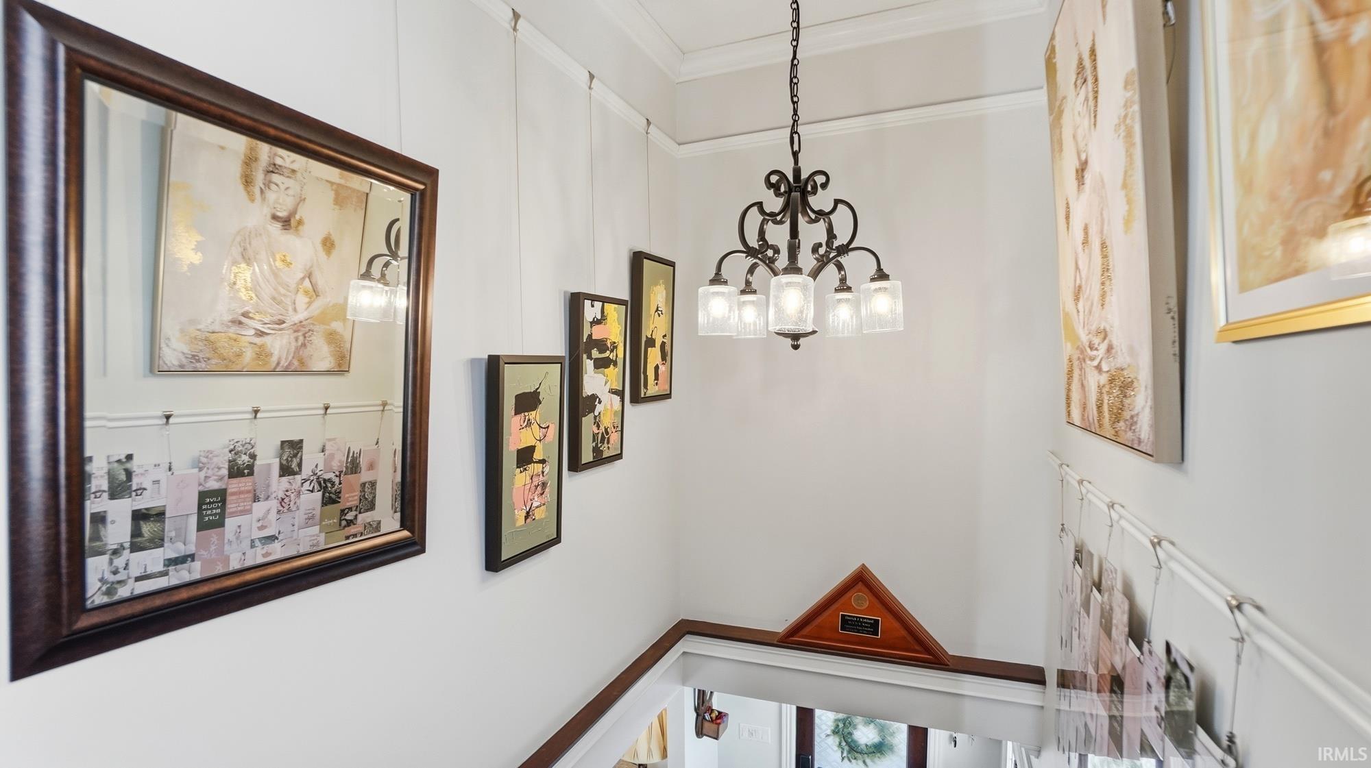 Corridor with a chandelier and ornamental molding