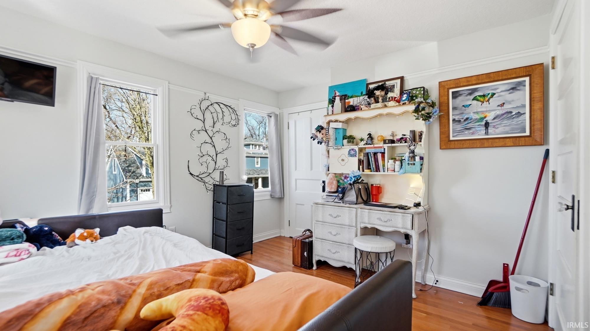 Bedroom featuring light wood finished floors and a ceiling fan