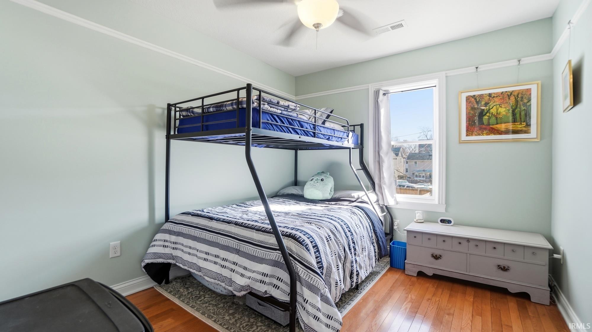 Bedroom featuring light wood-style floors and a ceiling fan