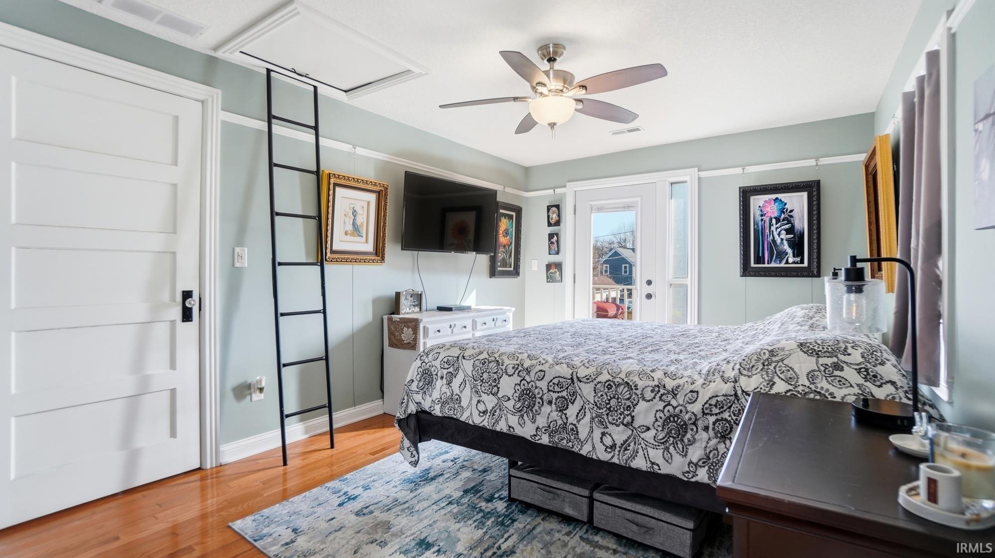 Bedroom featuring access to outside, a ceiling fan, and light wood finished floors