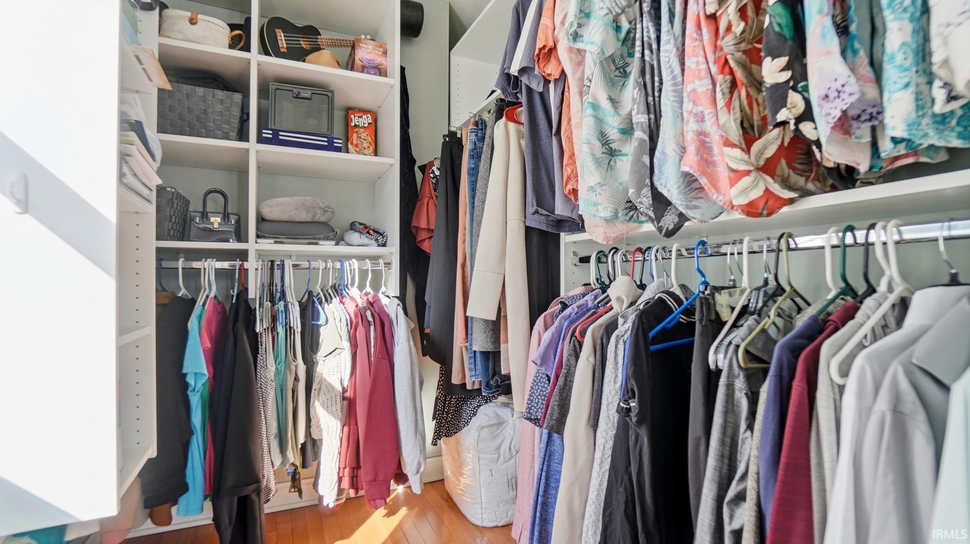 Walk in closet with light wood-type flooring