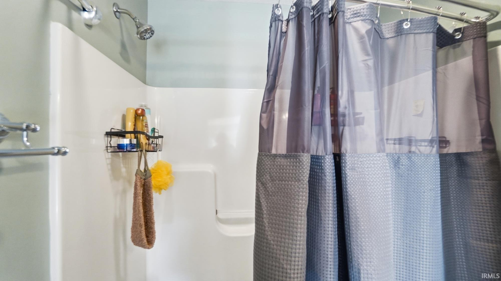 Full bathroom with a shower stall
