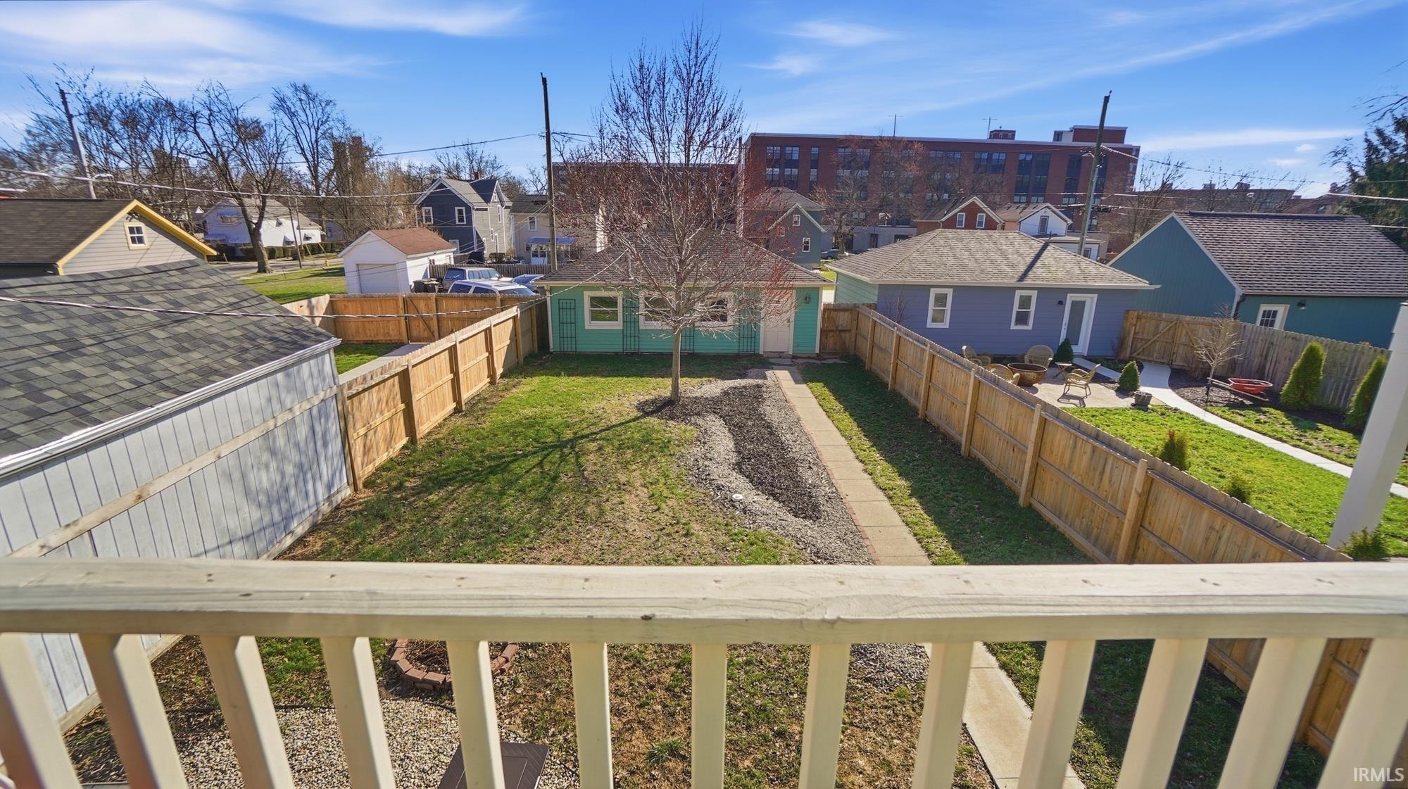 Fenced backyard with a residential view