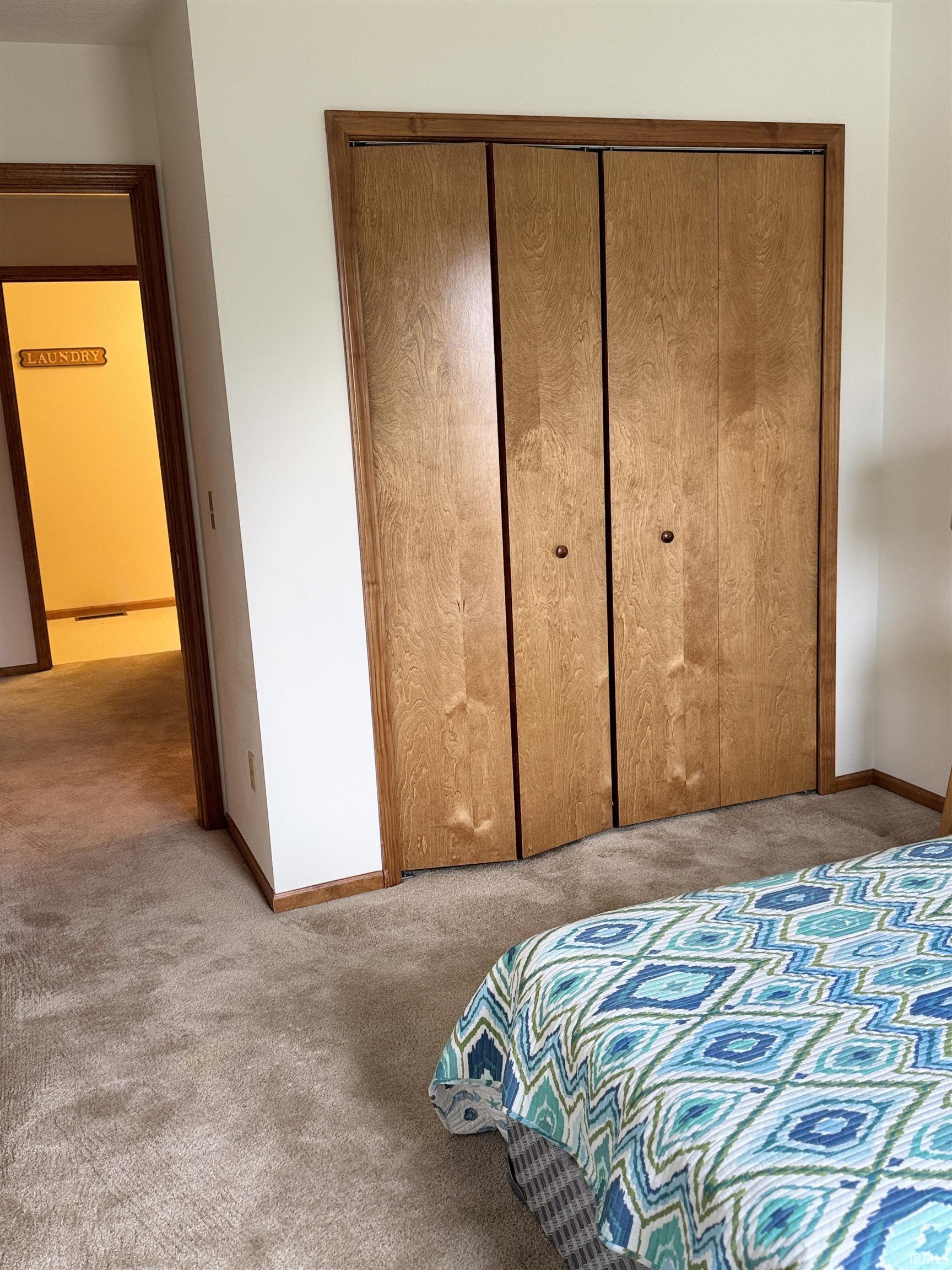 Bedroom featuring a closet and light carpet
