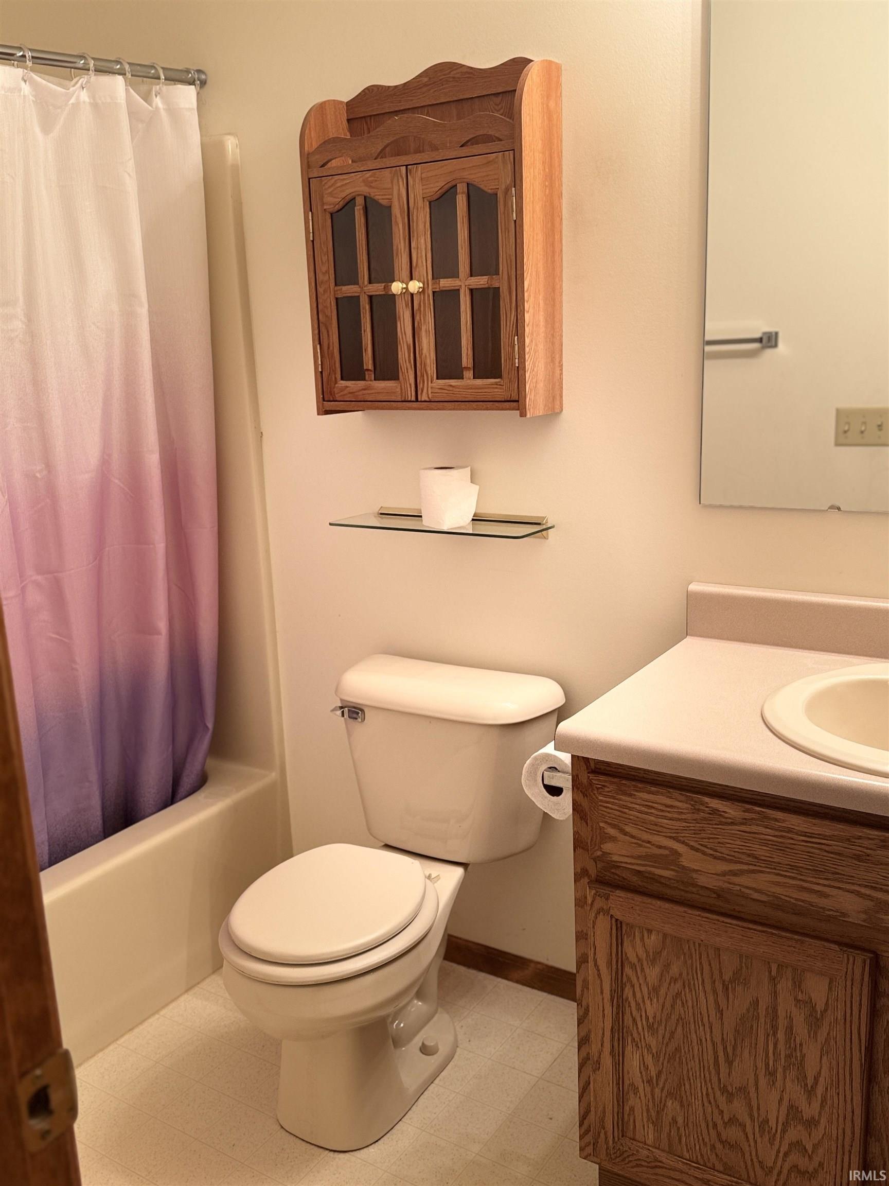 Full bath with vanity, light flooring, and shower / bath combination with curtain