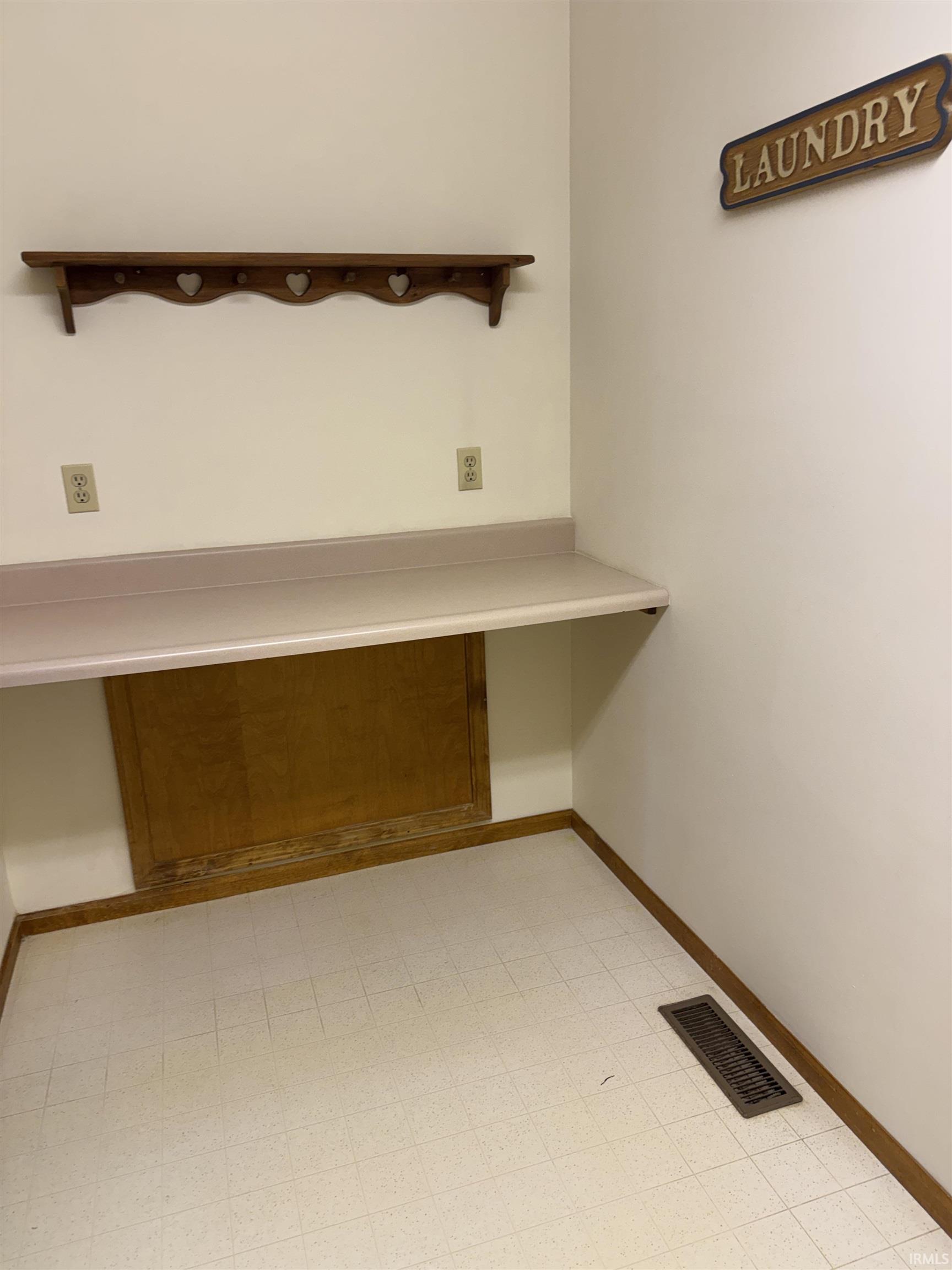 Unfurnished office featuring baseboards and light floors