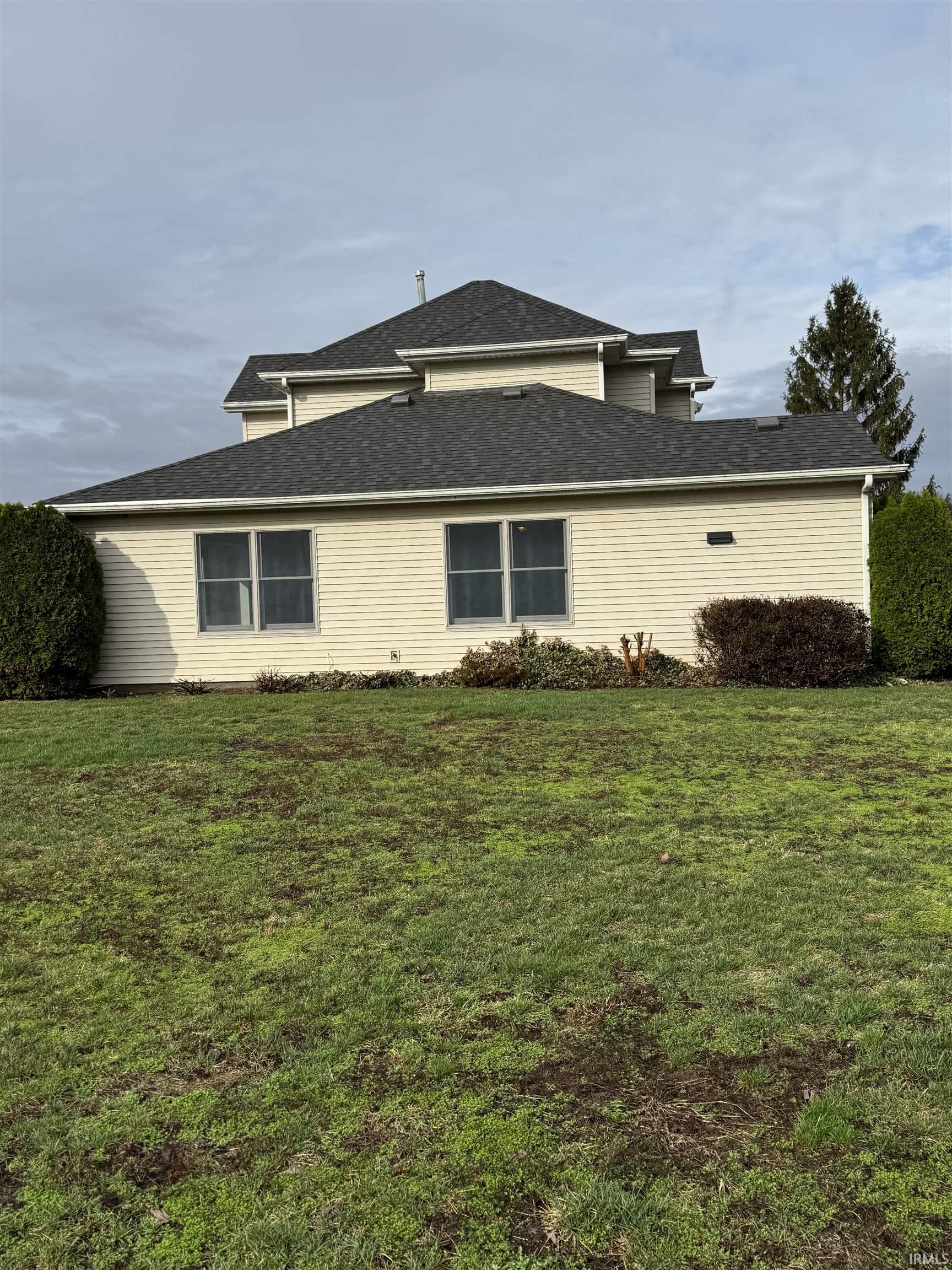 View of side of home with a lawn