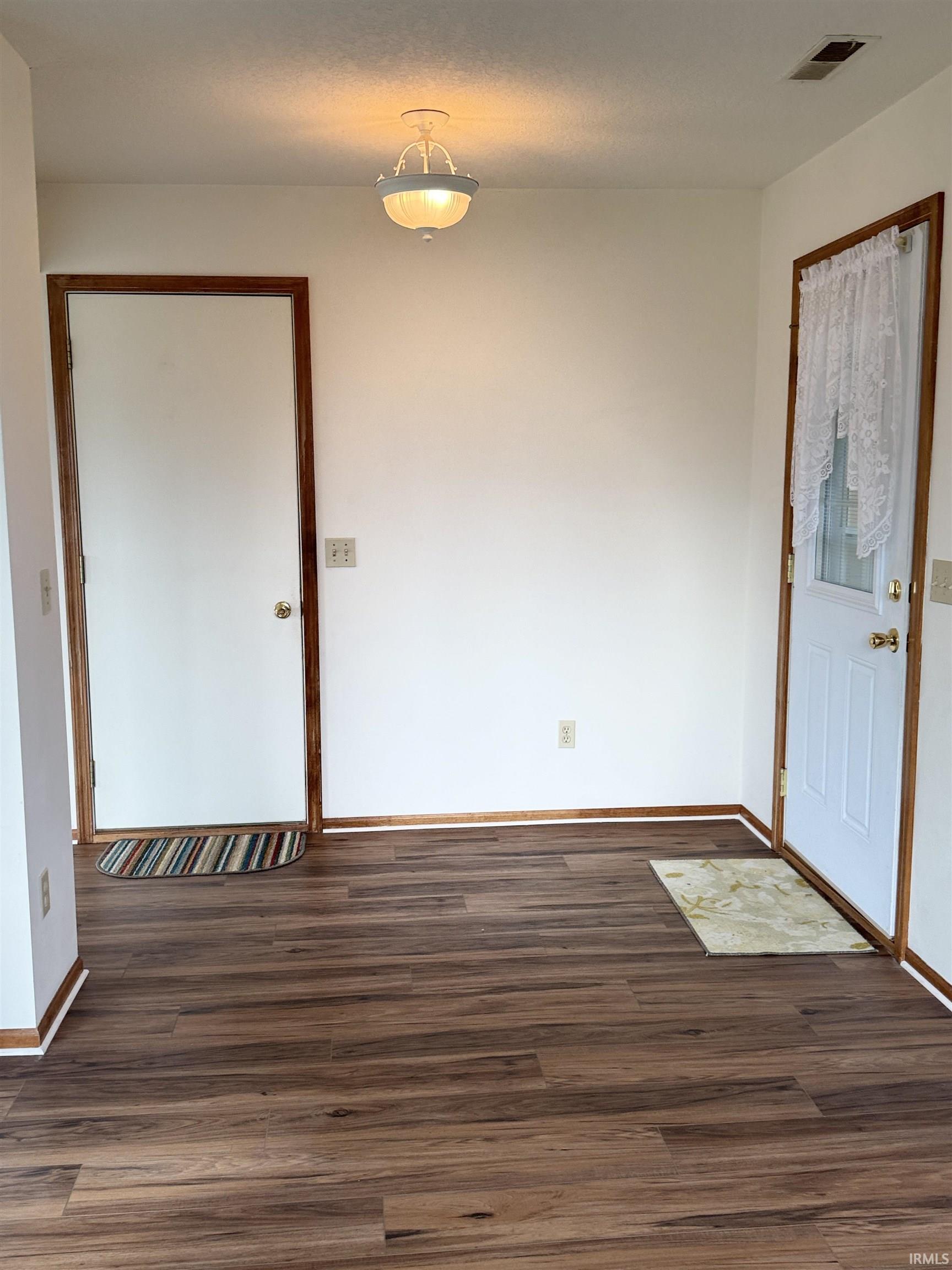 Foyer featuring dark wood-style floors
