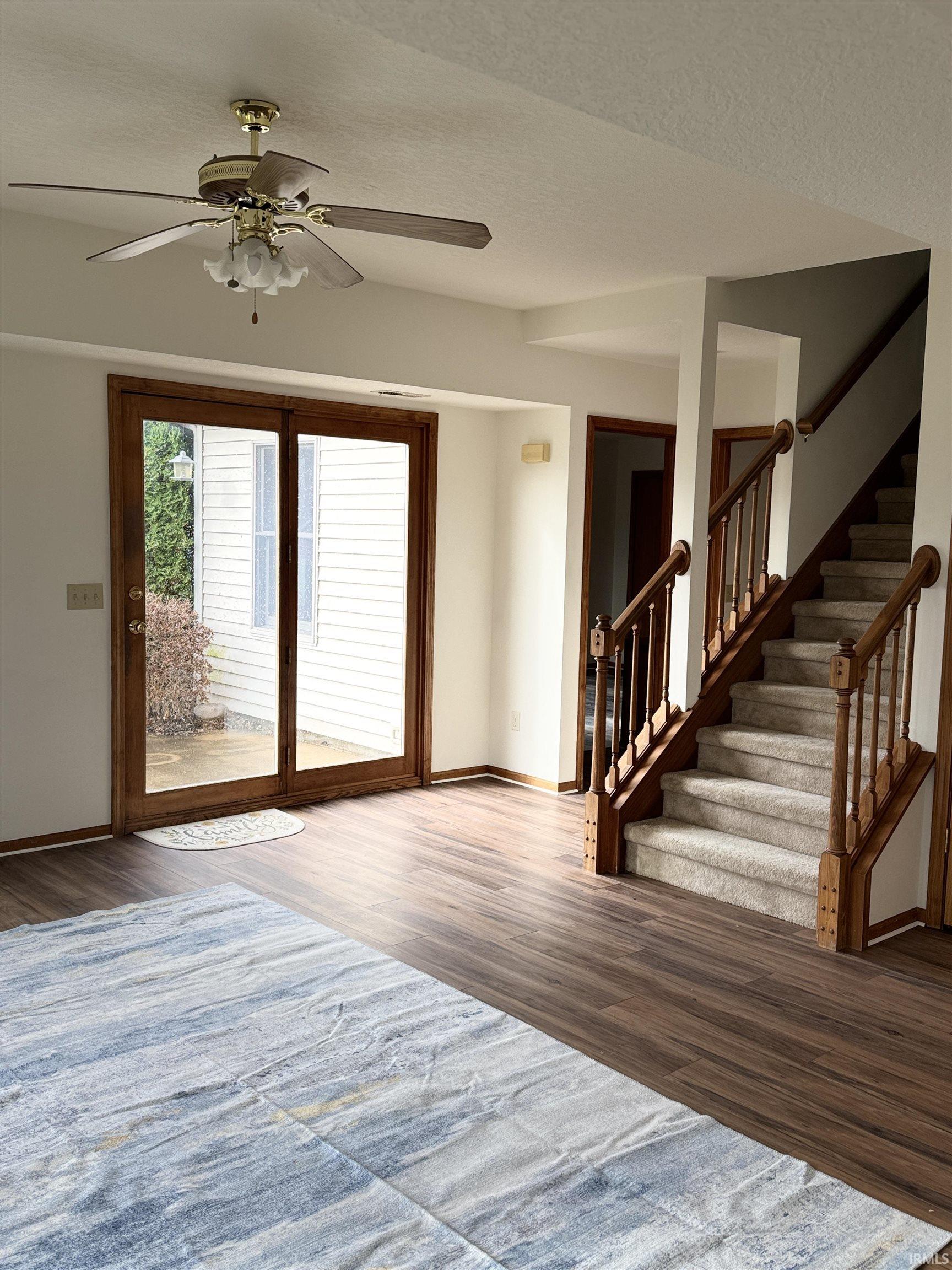 Foyer entrance featuring dark wood finished floors and a ceiling fan