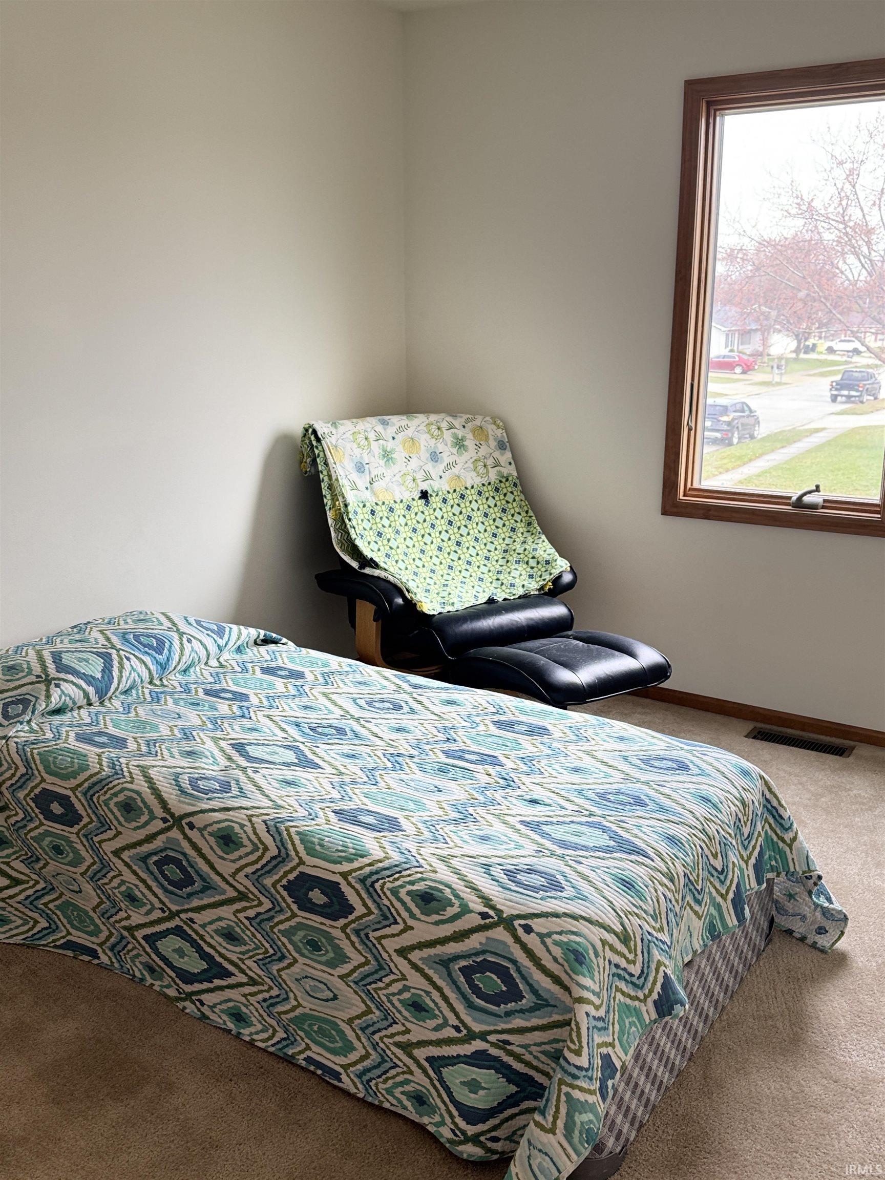 Carpeted bedroom featuring baseboards