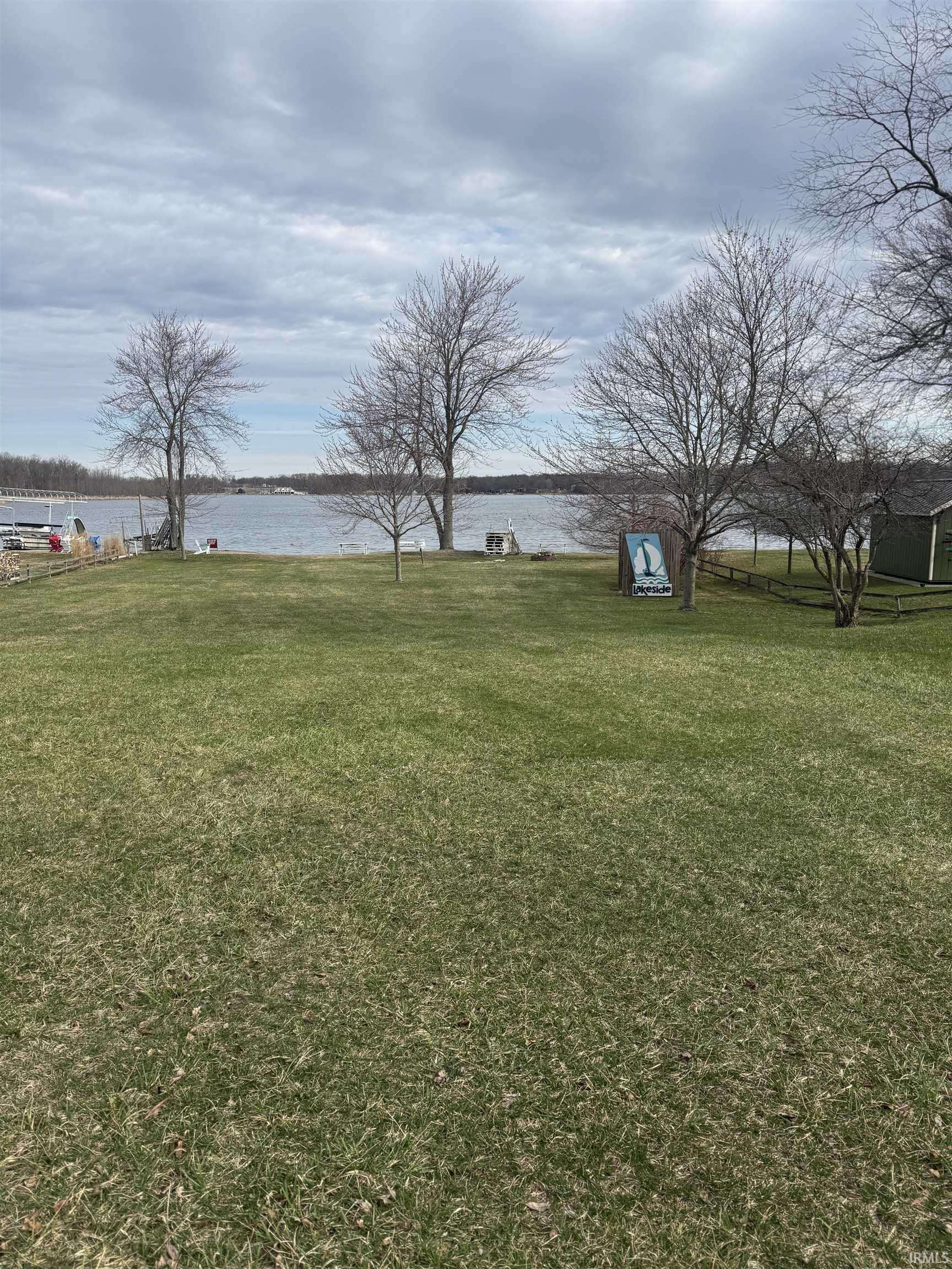 View of green lawn featuring a water view