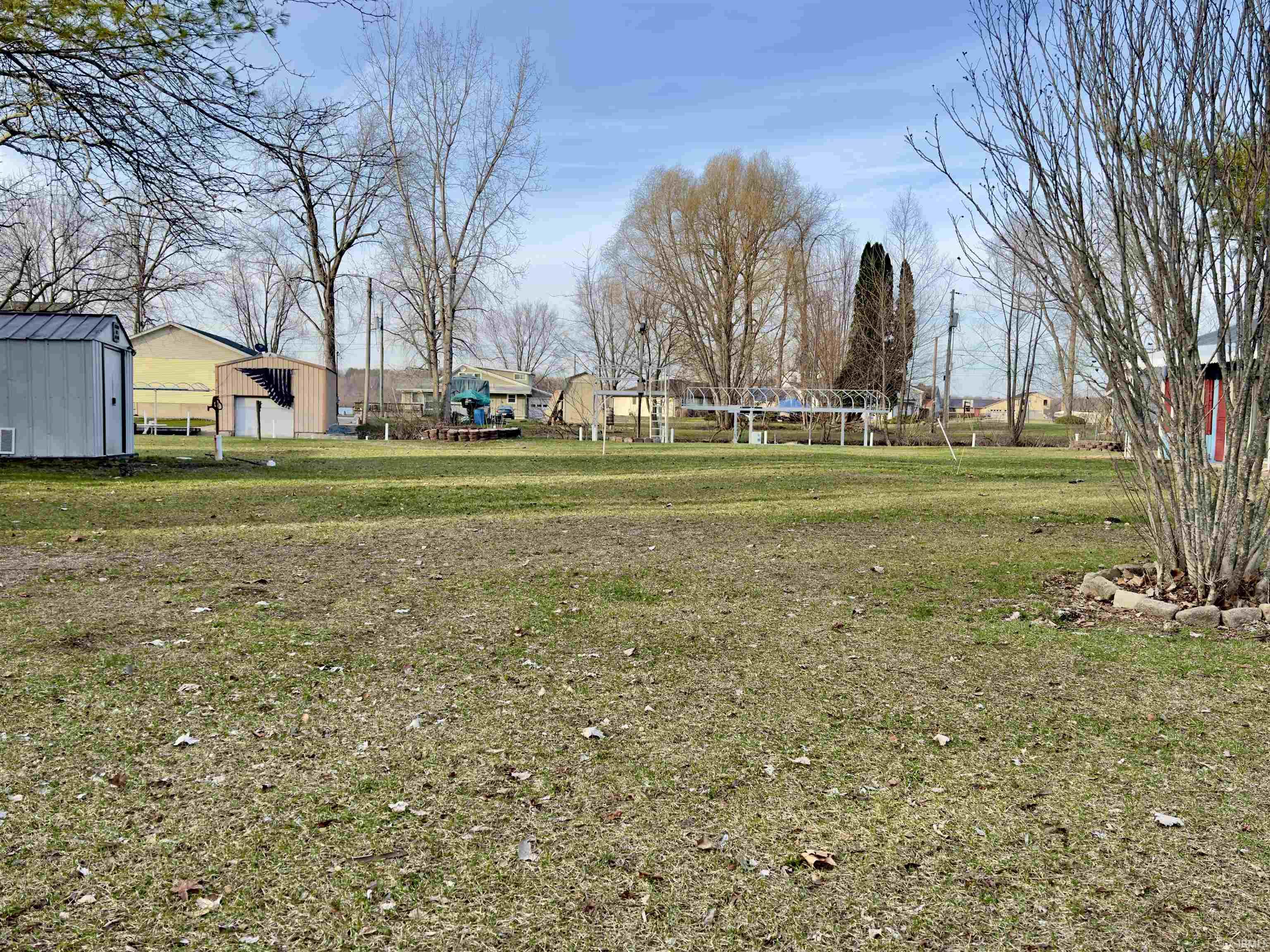View of green lawn with an outbuilding
