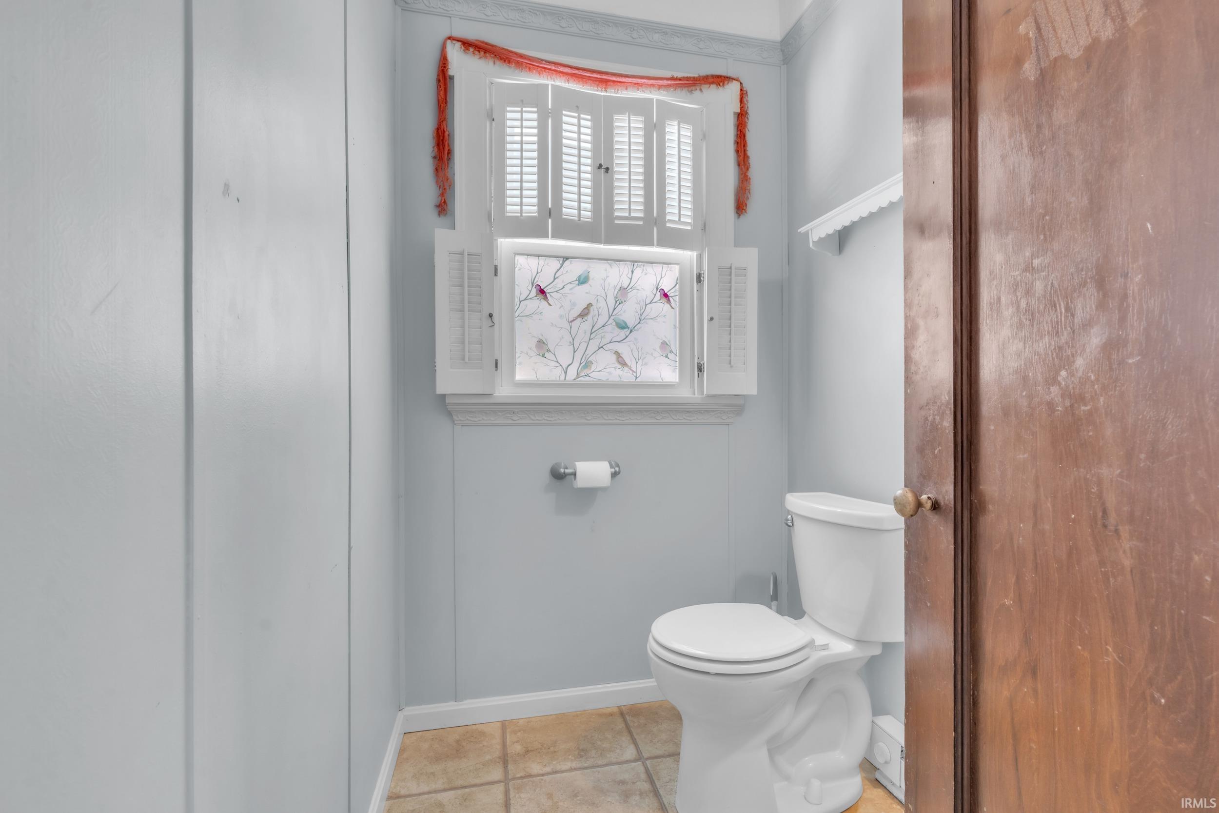 Bathroom featuring toilet and baseboards