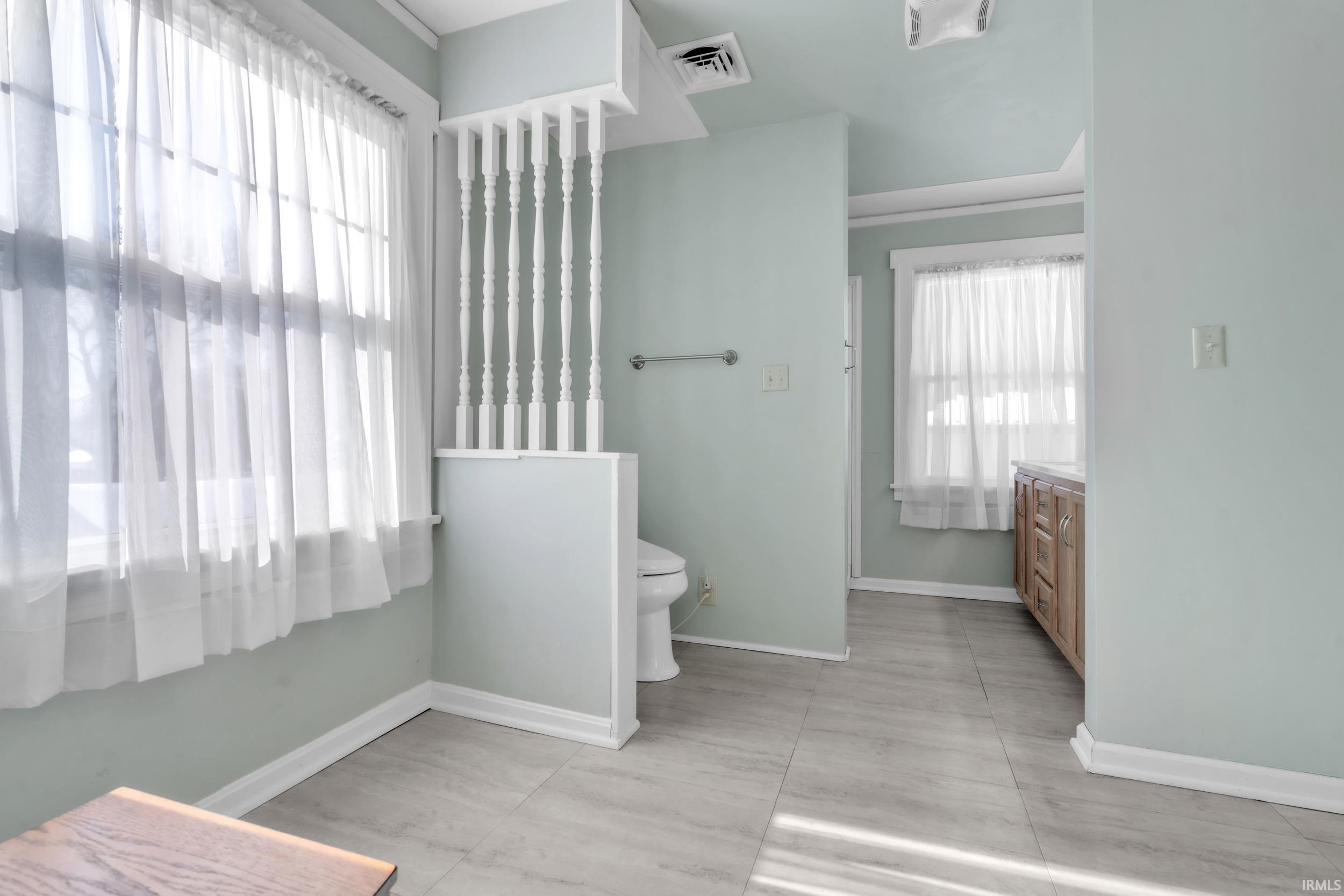 Full bath with baseboards and vanity