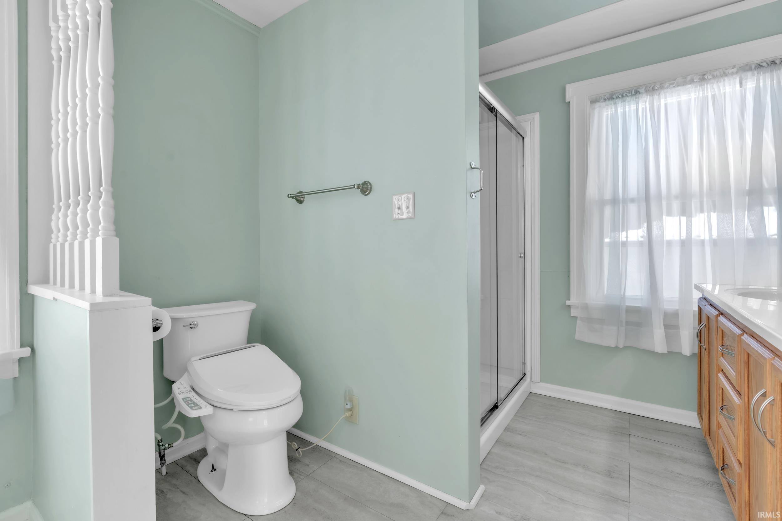 Bathroom with a shower stall and vanity