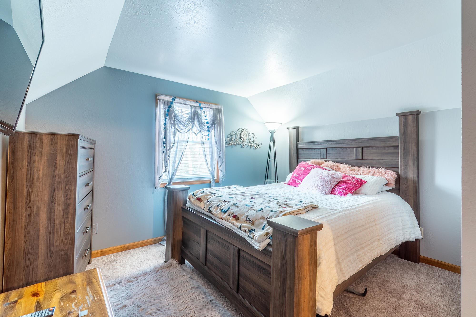 Bedroom with light carpet and a textured ceiling