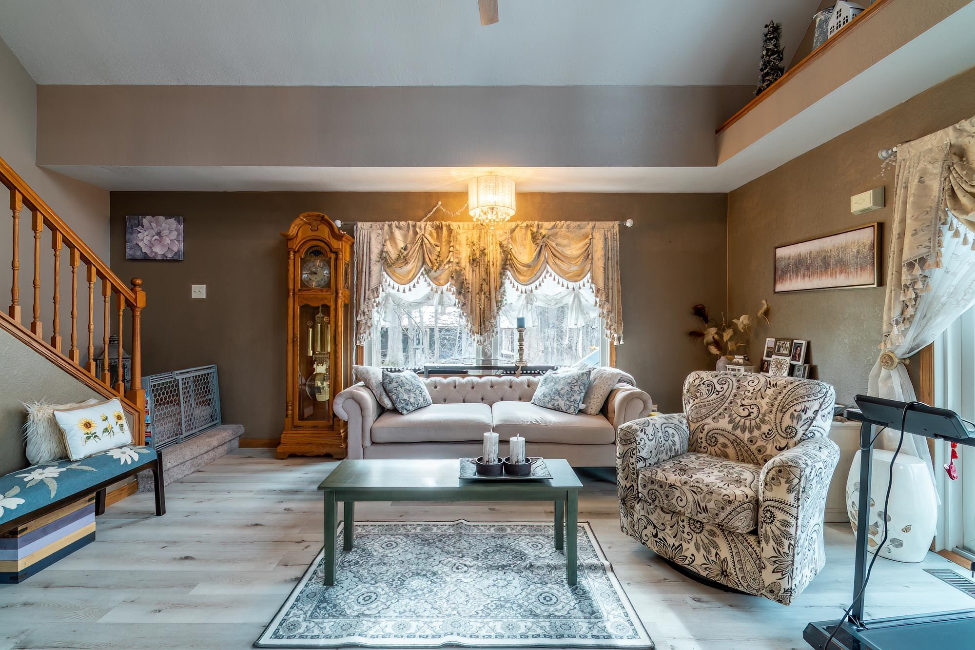 Living area featuring wood finished floors and suspended lighting