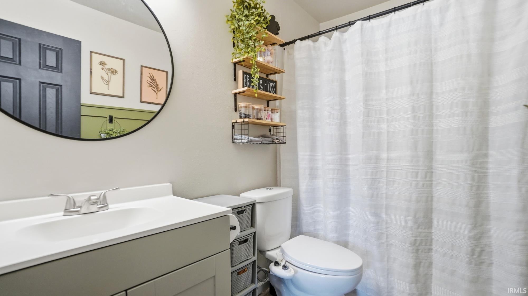 Full bath with vanity and a shower with shower curtain