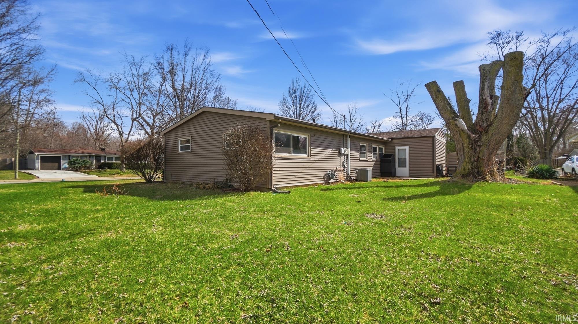 Rear view of house featuring a lawn