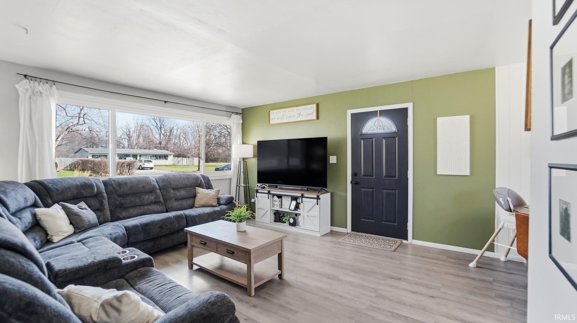 Living room featuring light wood finished floors and baseboards