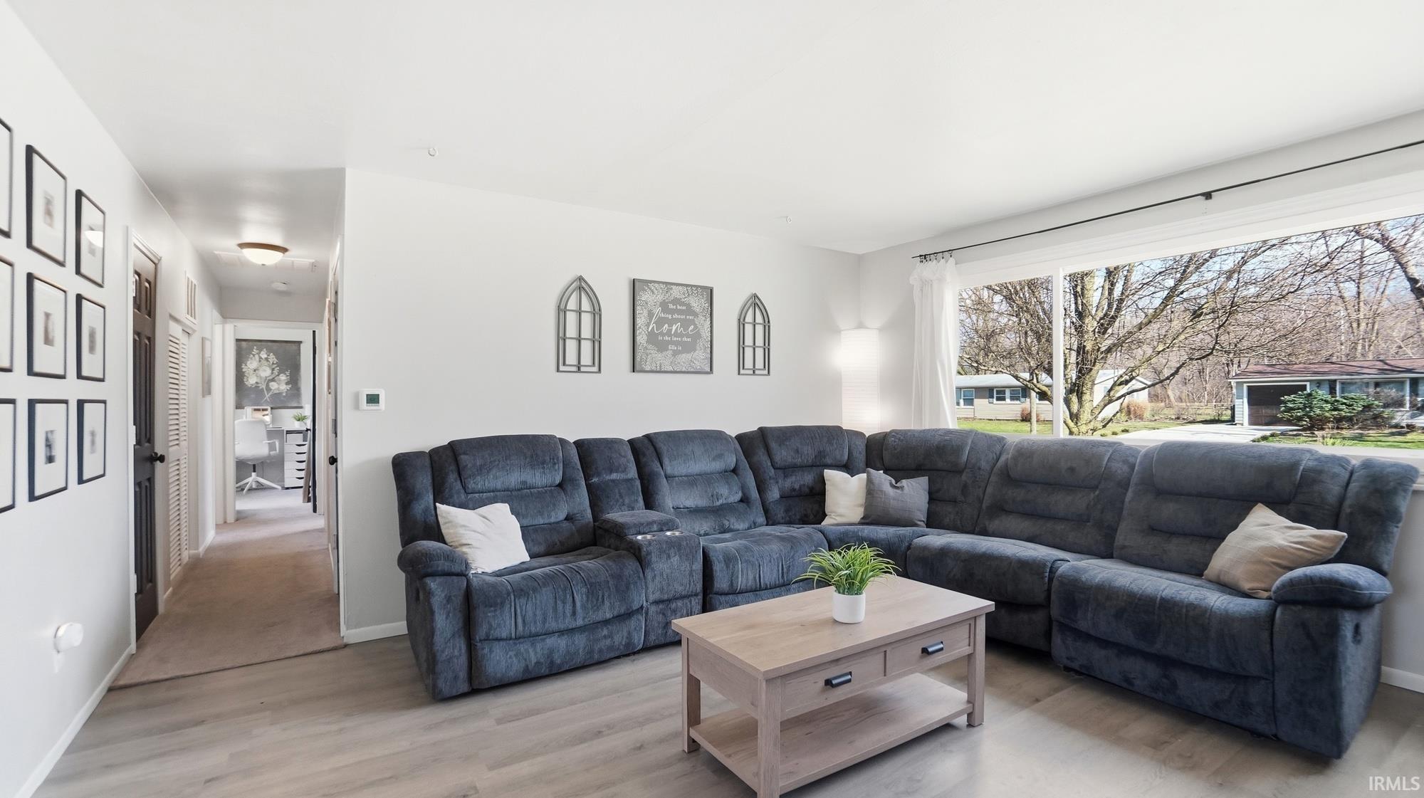 Living room with light wood finished floors and baseboards
