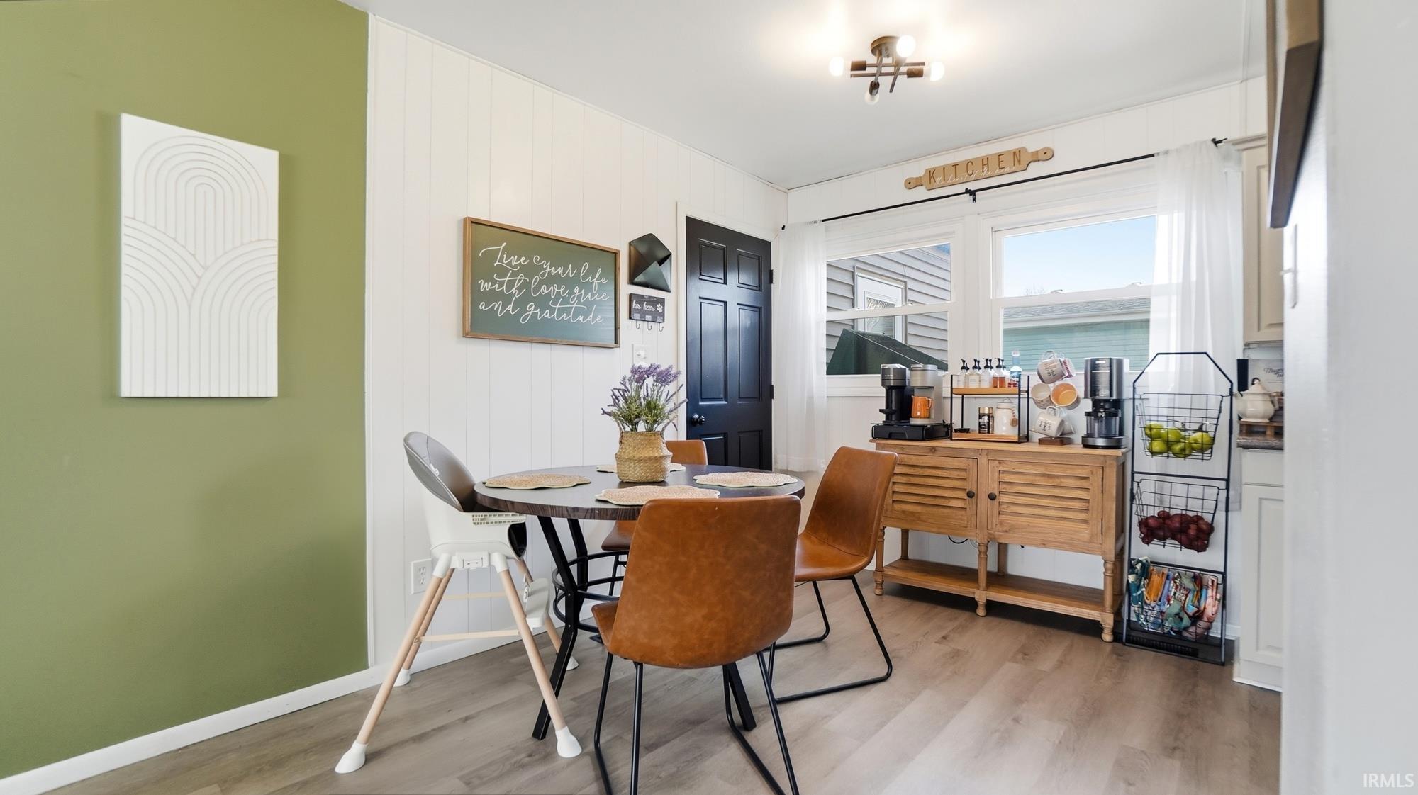 Dining room featuring light wood-type flooring and baseboards