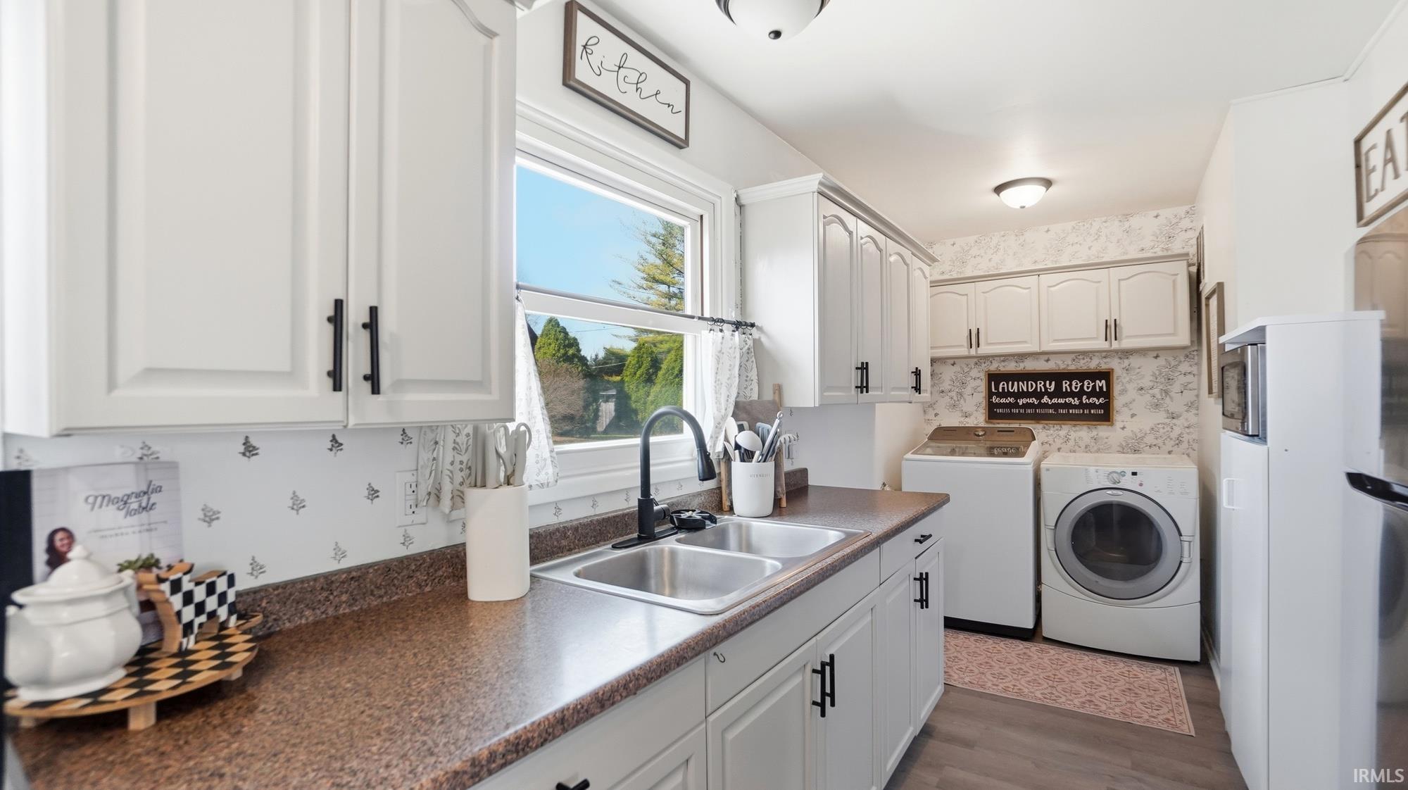 Kitchen with dark countertops and white cabinetry