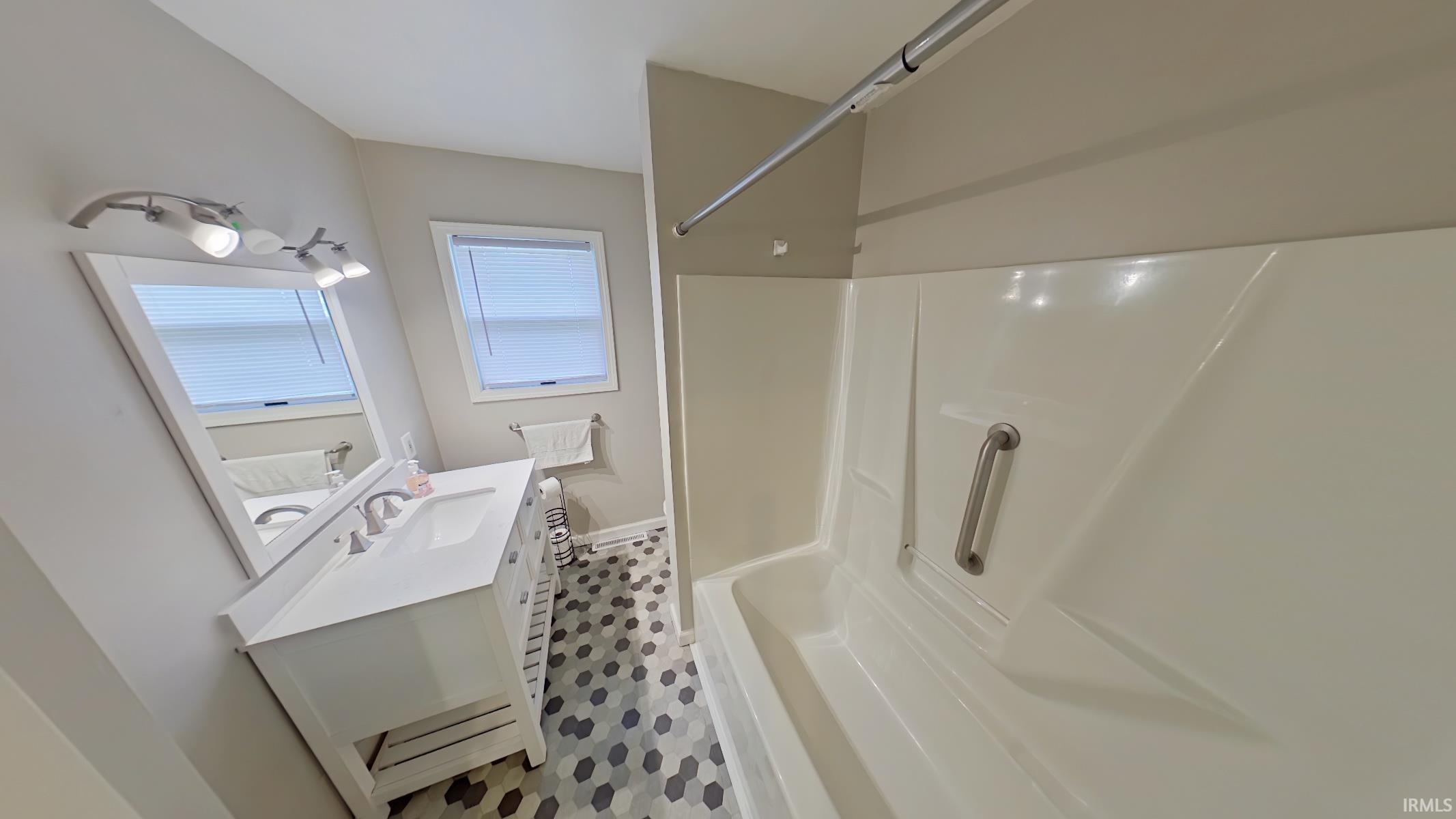 Full bathroom featuring vanity and light flooring