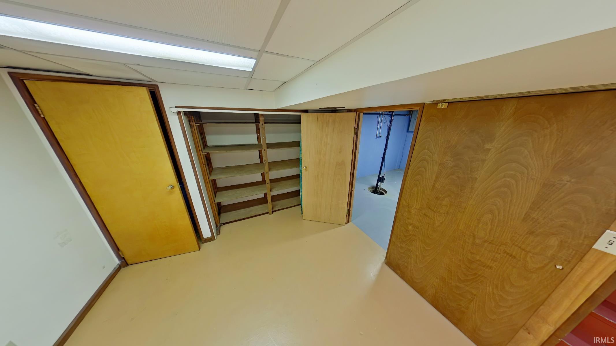 Finished basement featuring a drop ceiling