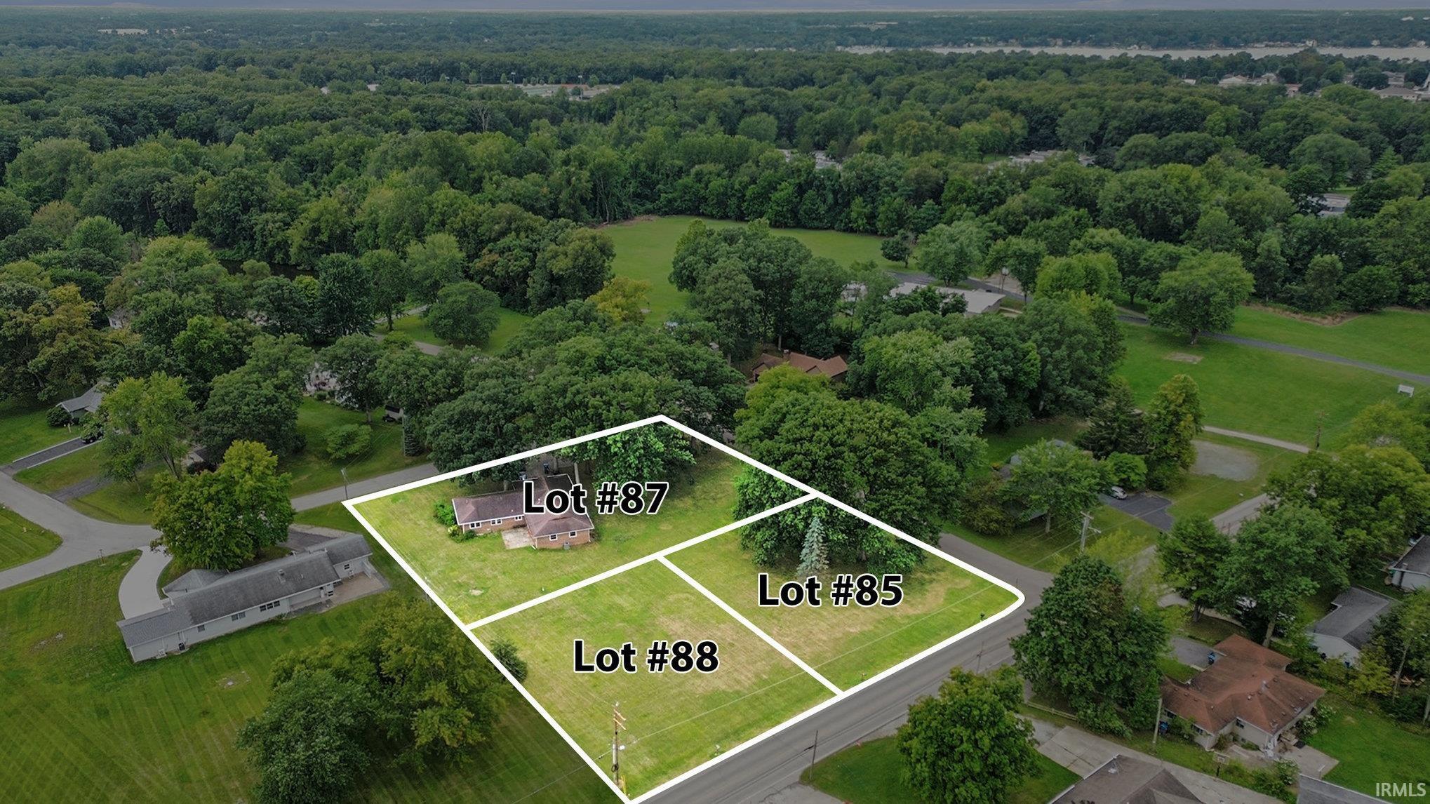 Aerial view of property and surrounding area with property parcel outlined