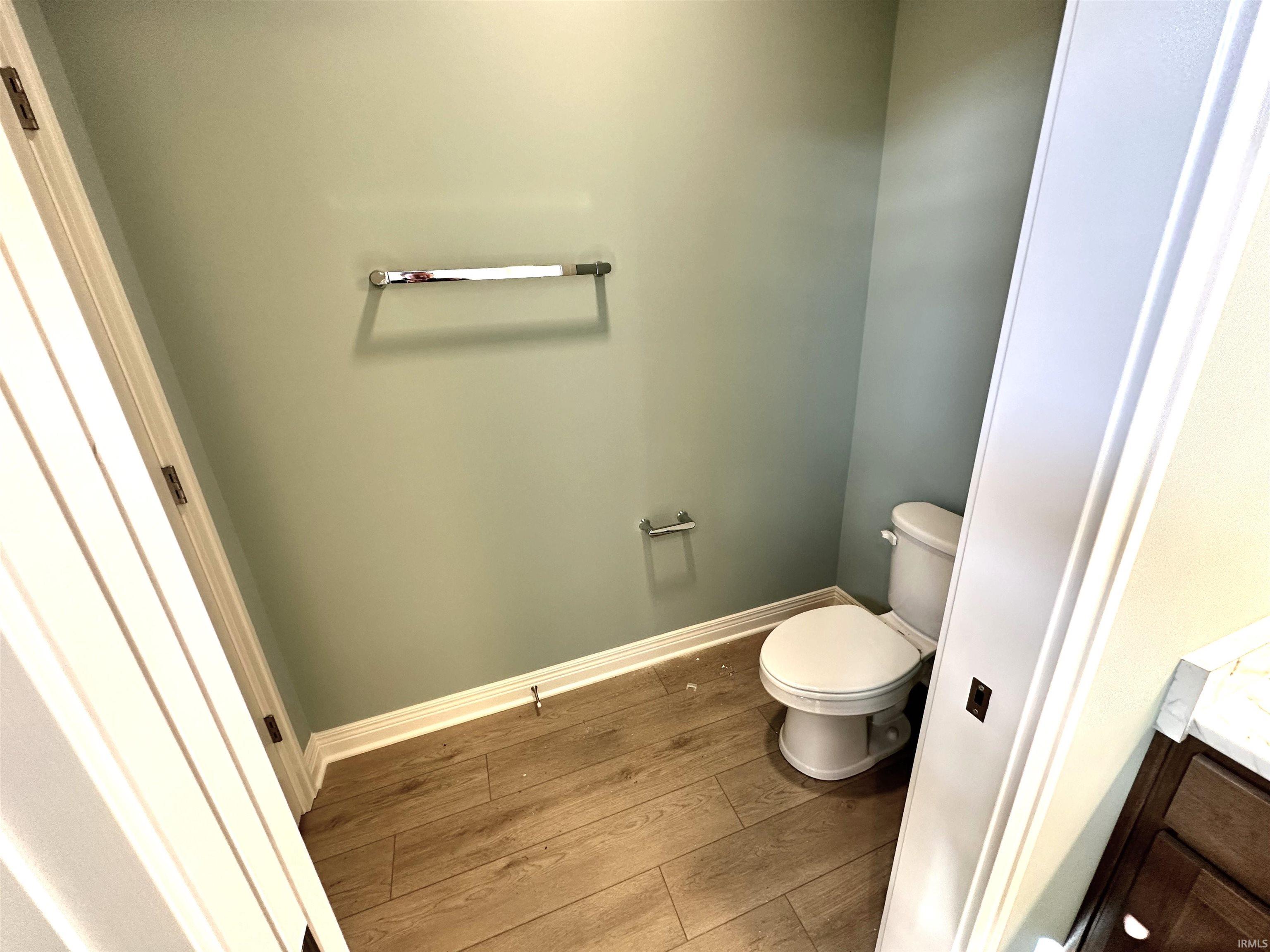 Bathroom with hardwood / wood-style flooring and vanity