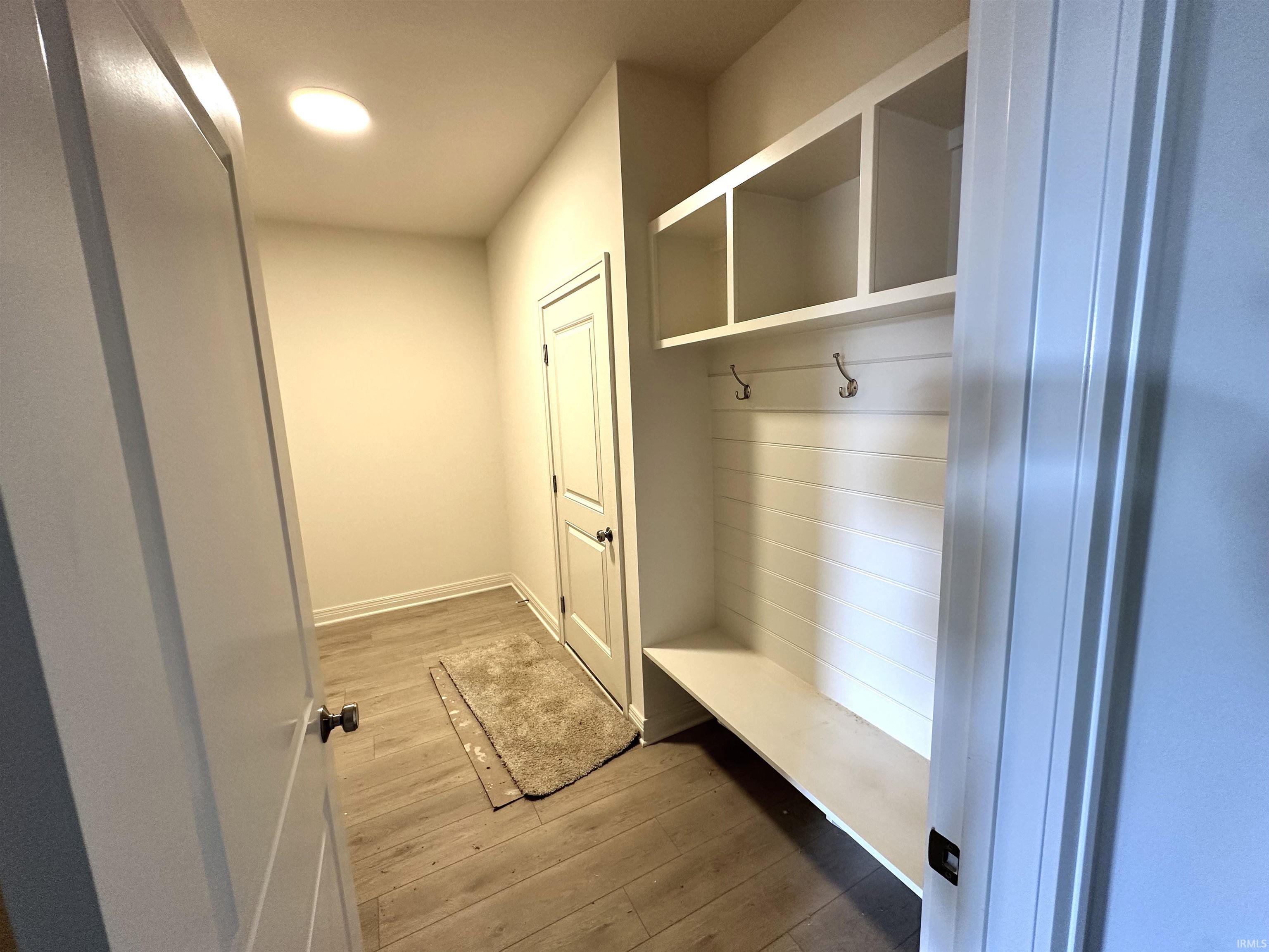 Mudroom featuring light wood-type flooring and recessed lighting