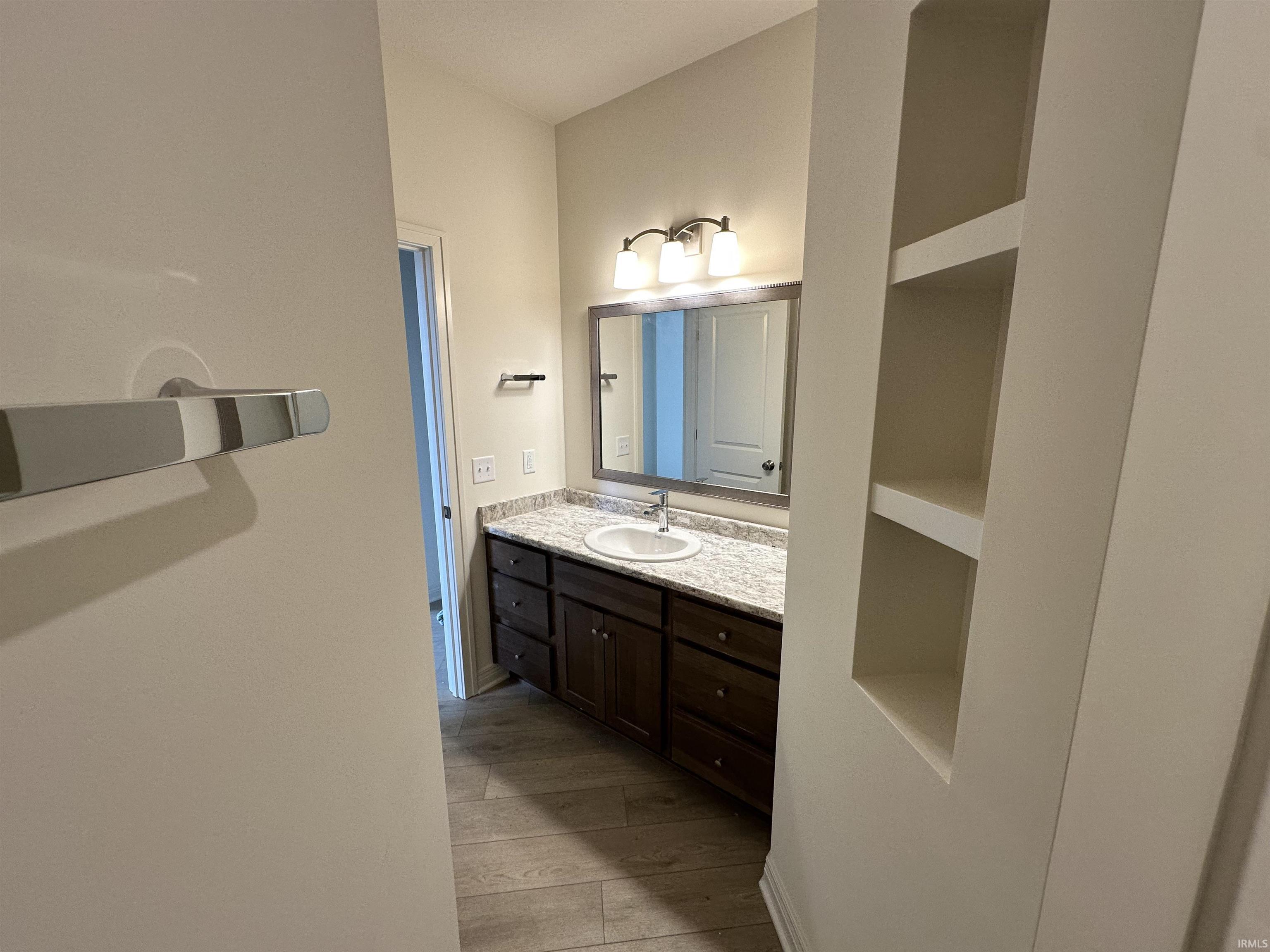 Bathroom featuring vanity and light wood finished floors