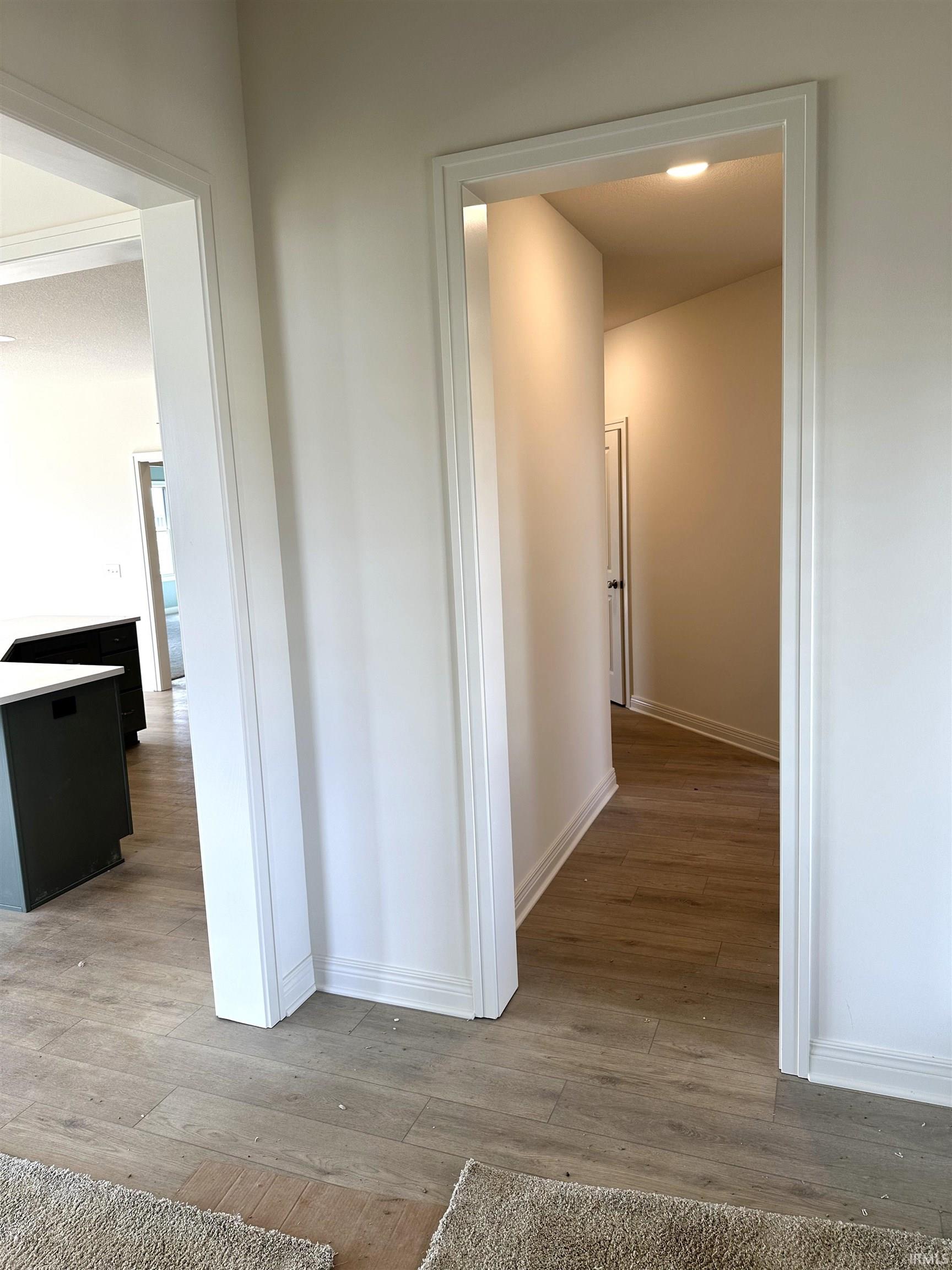 Hallway with light wood finished floors