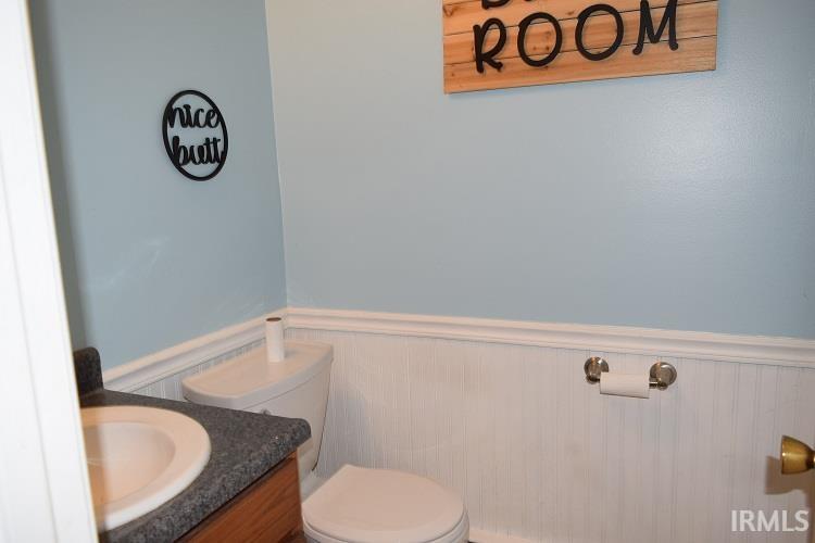 Bathroom with vanity and a wainscoted wall